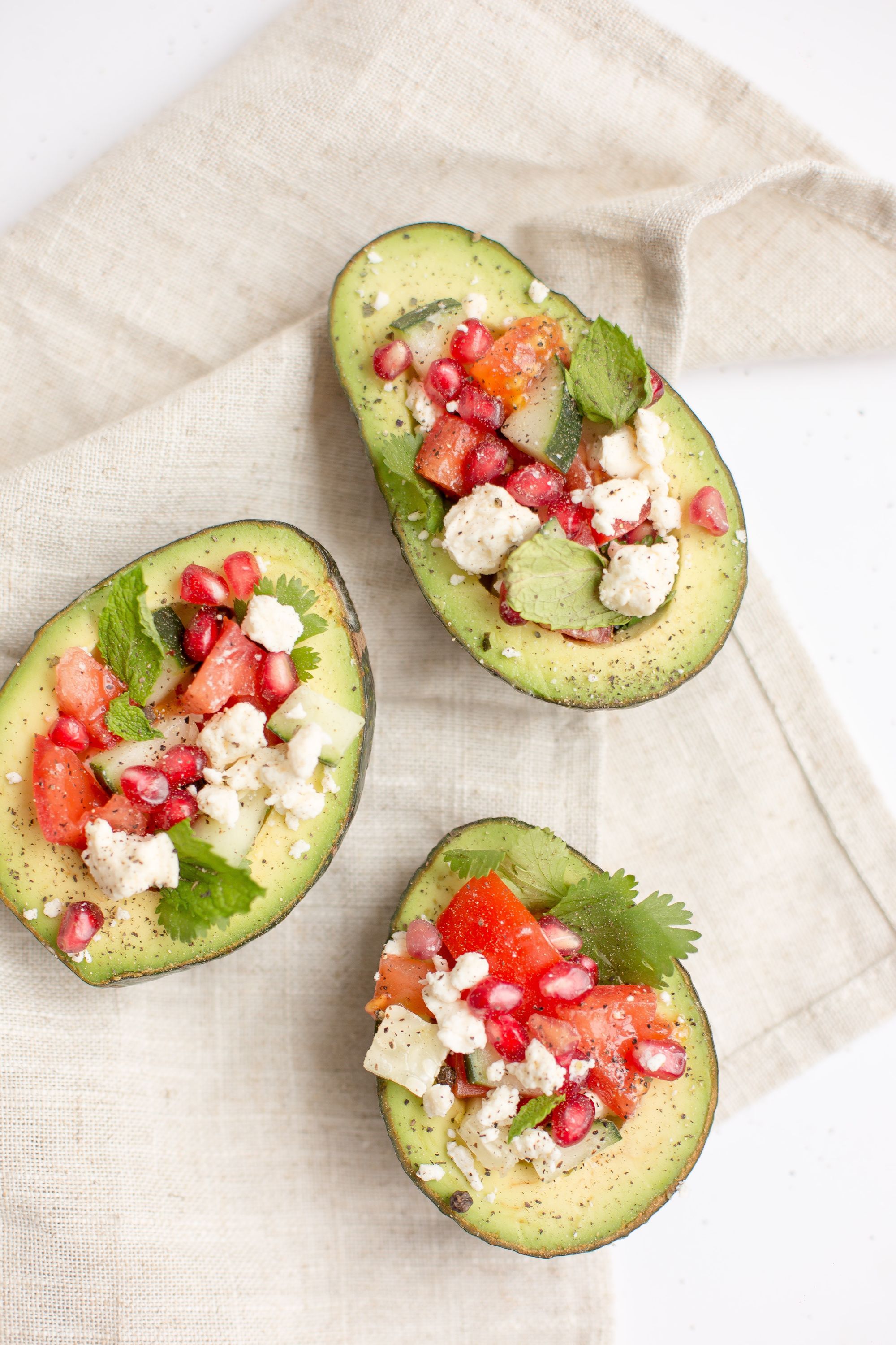 Mediterranian stuffed avocado with feta, pomegranate and cucumber