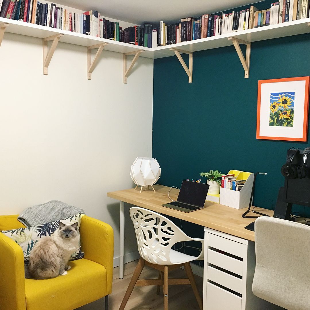 Home office nook with a corner bookshelf