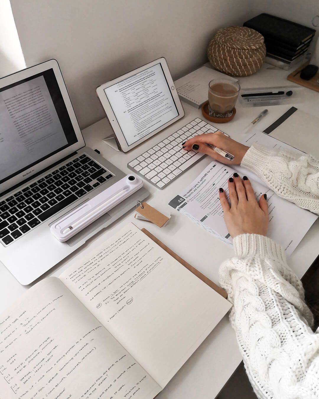 Liv masters multitasking by utilising two screens and paper notebooks at the same time