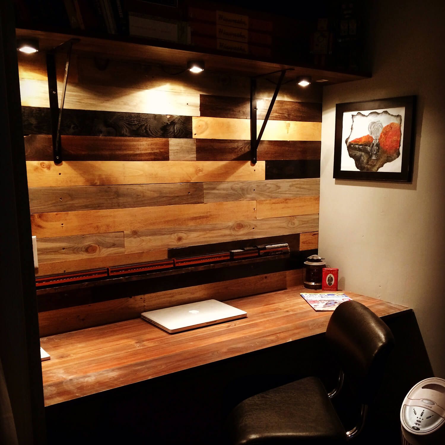 Reddit user Corbin1 mounted puck lights under the shelf at his cloffice