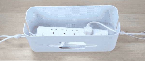 Put the power strip into the cable box for a tidy look