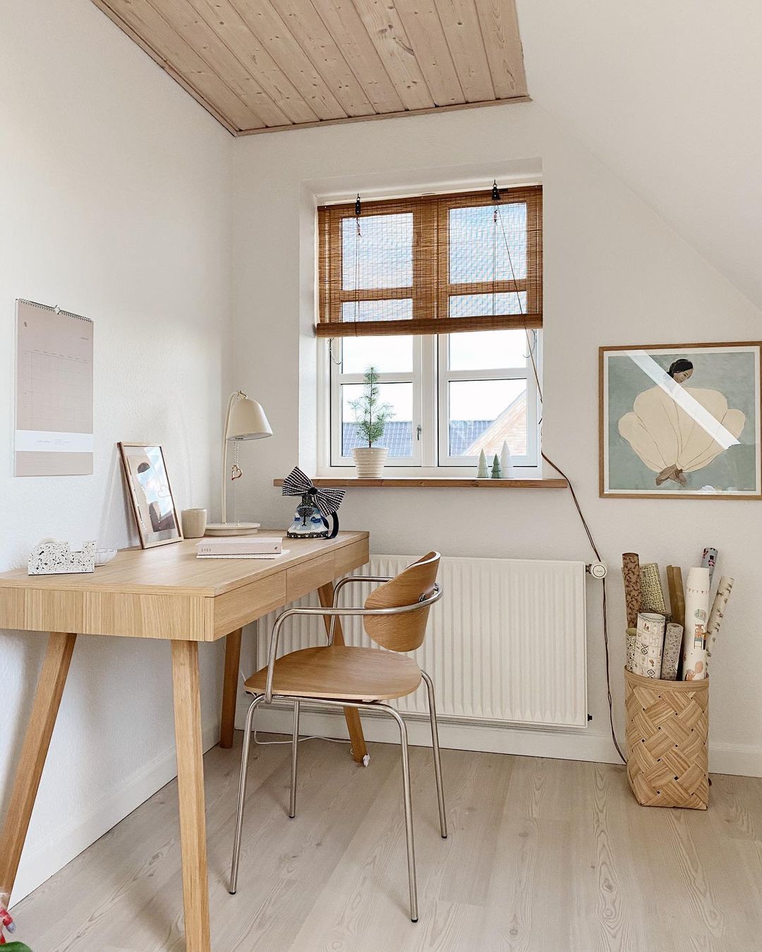 A home office with bamboo blinds