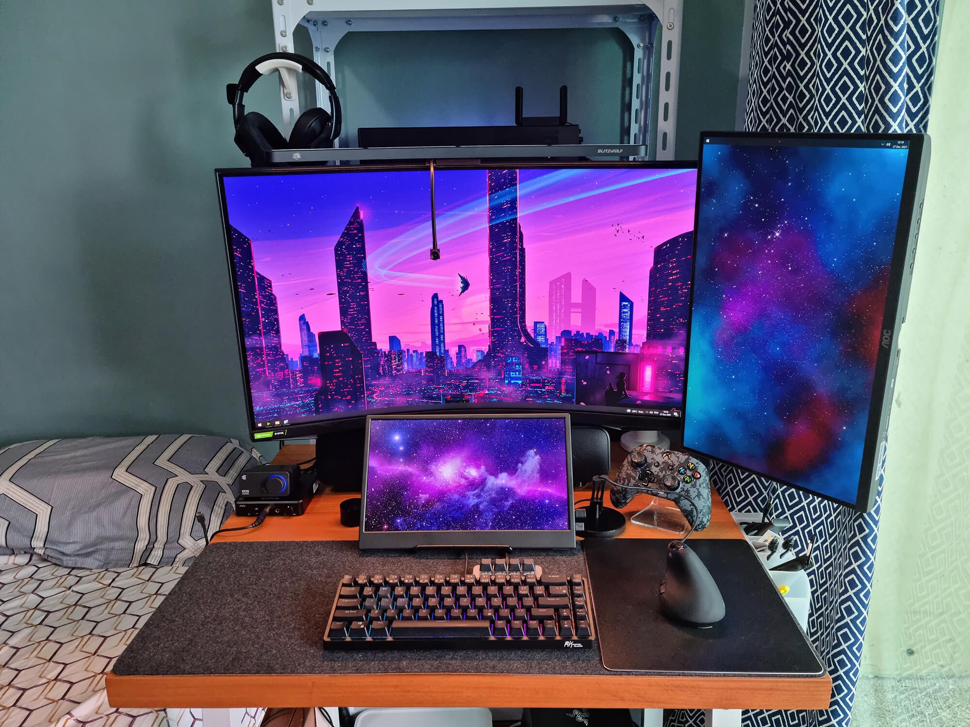 A small home office desk setup with a curved monitor