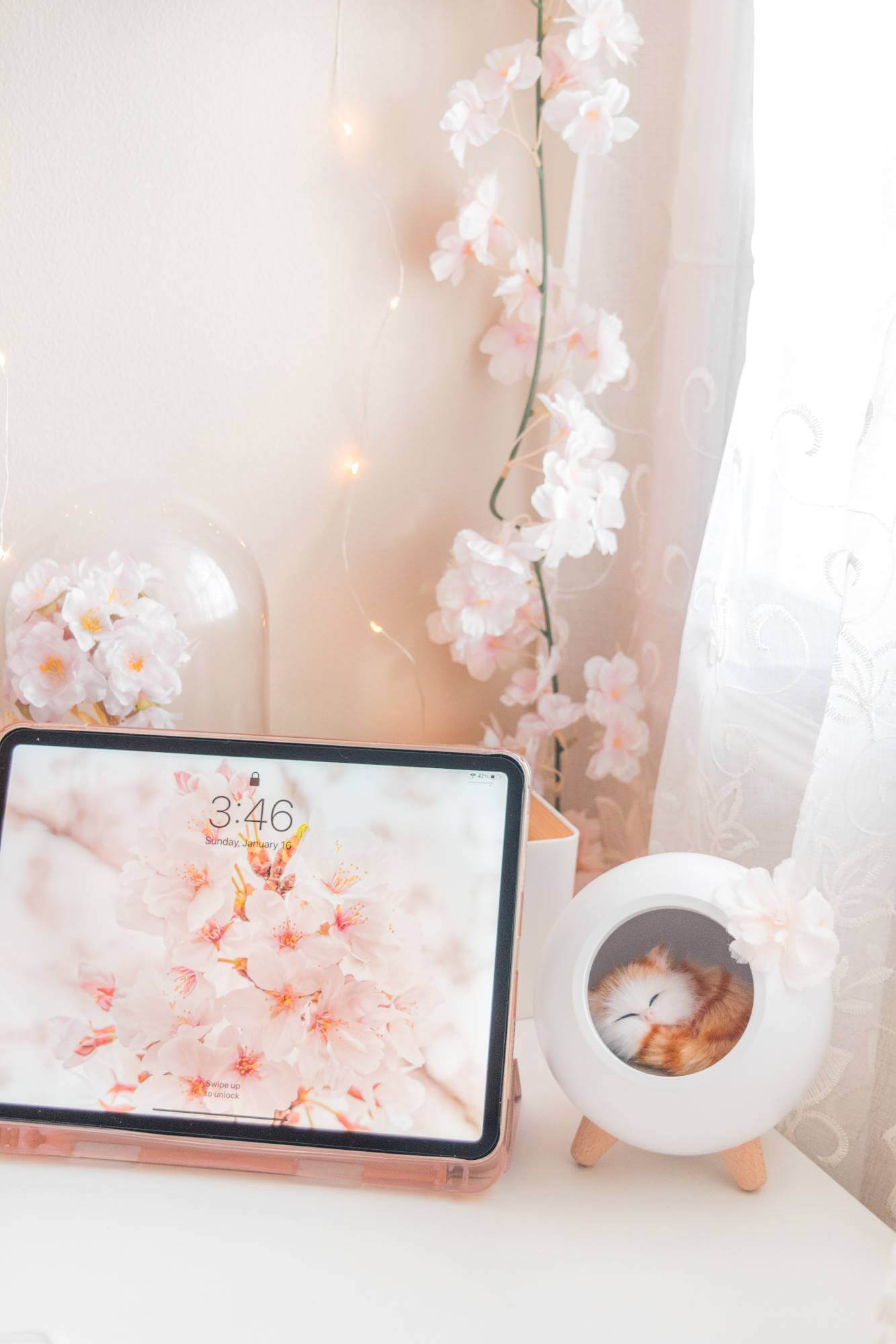 An iPad with a cherry blossom wallpaper