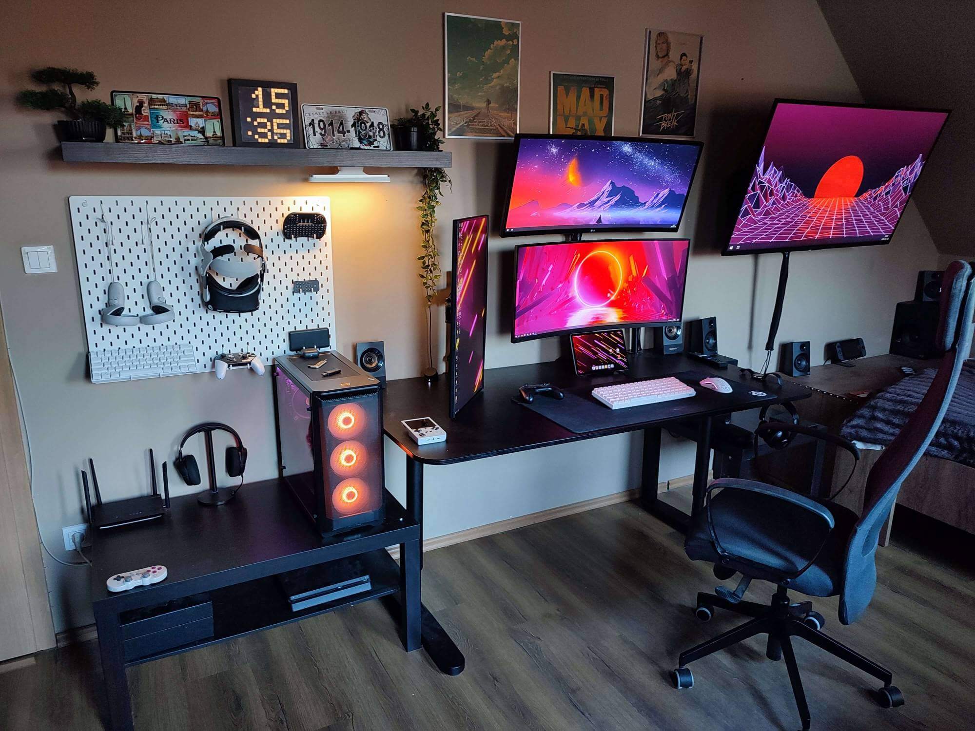 Desk setup with four screens in a home workspace