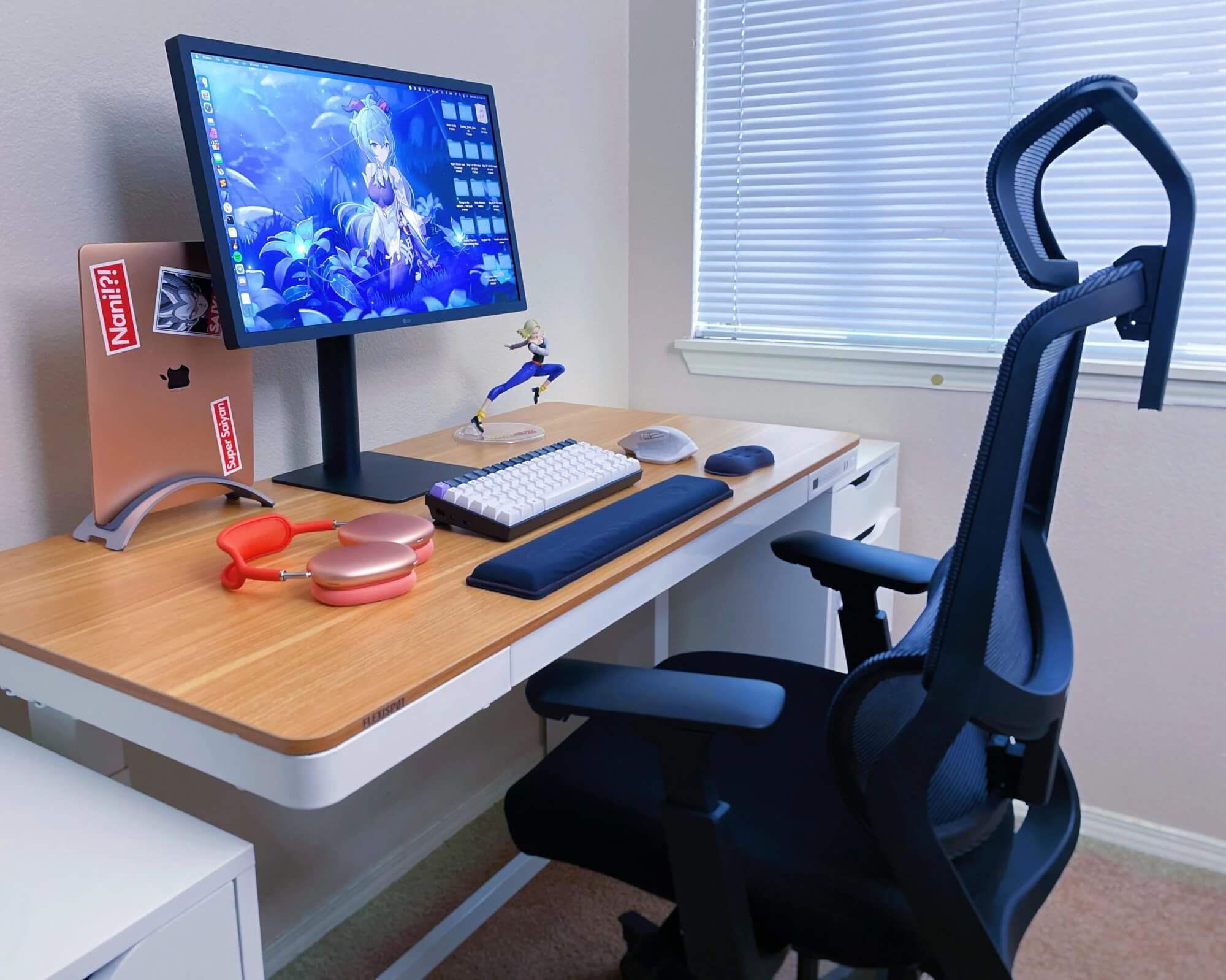 A small home office desk setup with a FlexiSpot standing desk