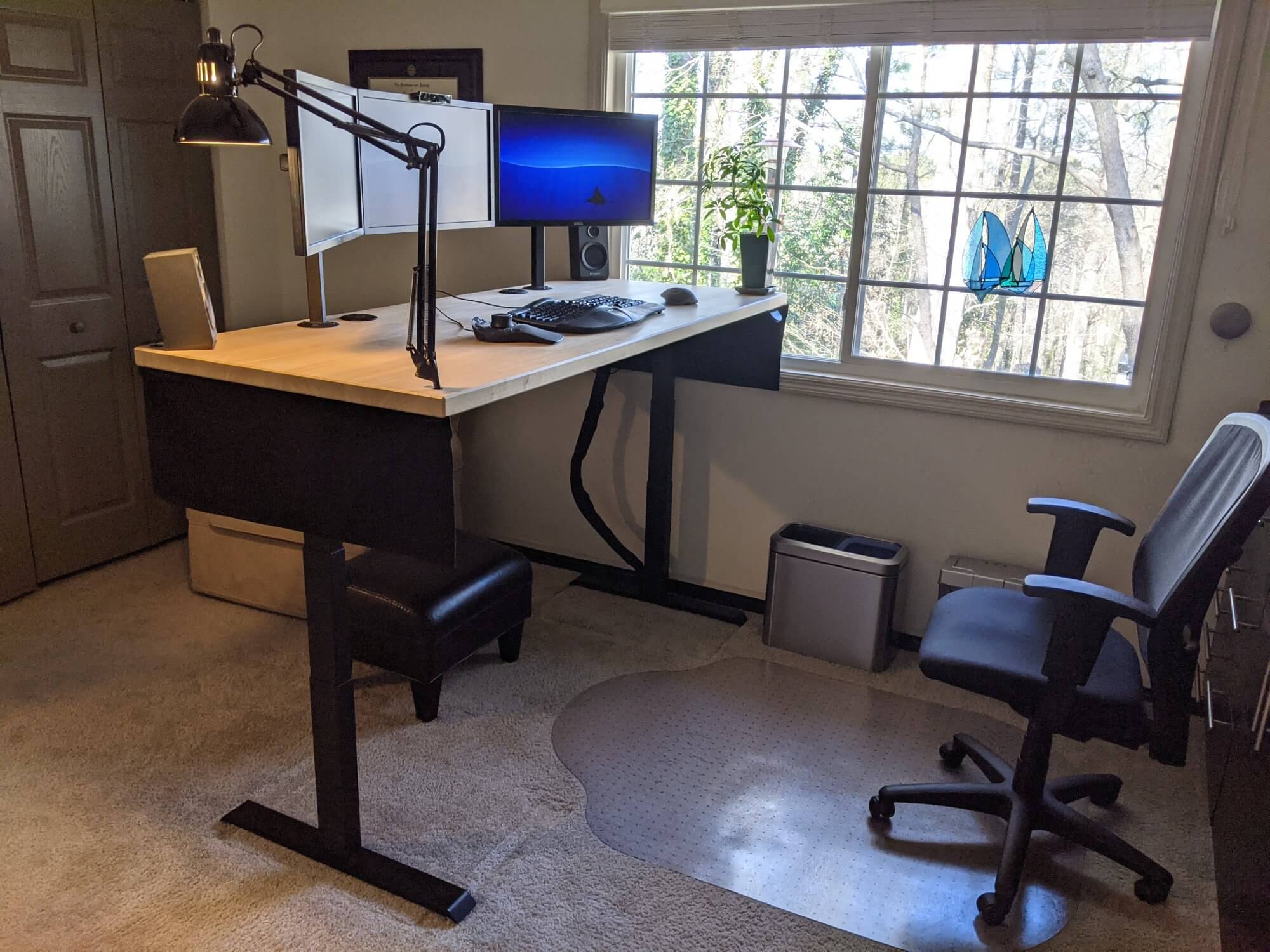 An Apex sit-stand desk with a butcher block countertop