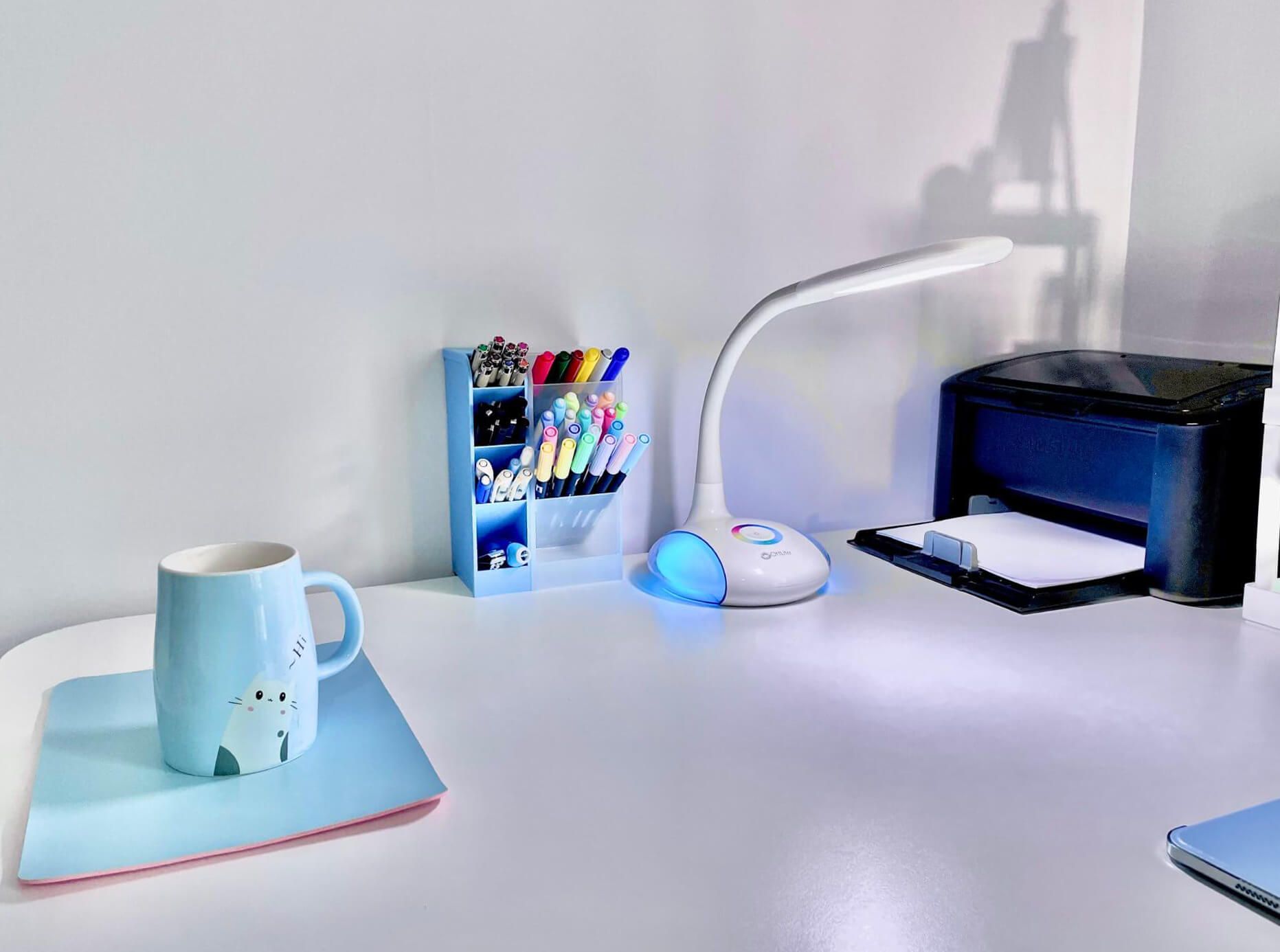 A corner desk with blue-themed accessories