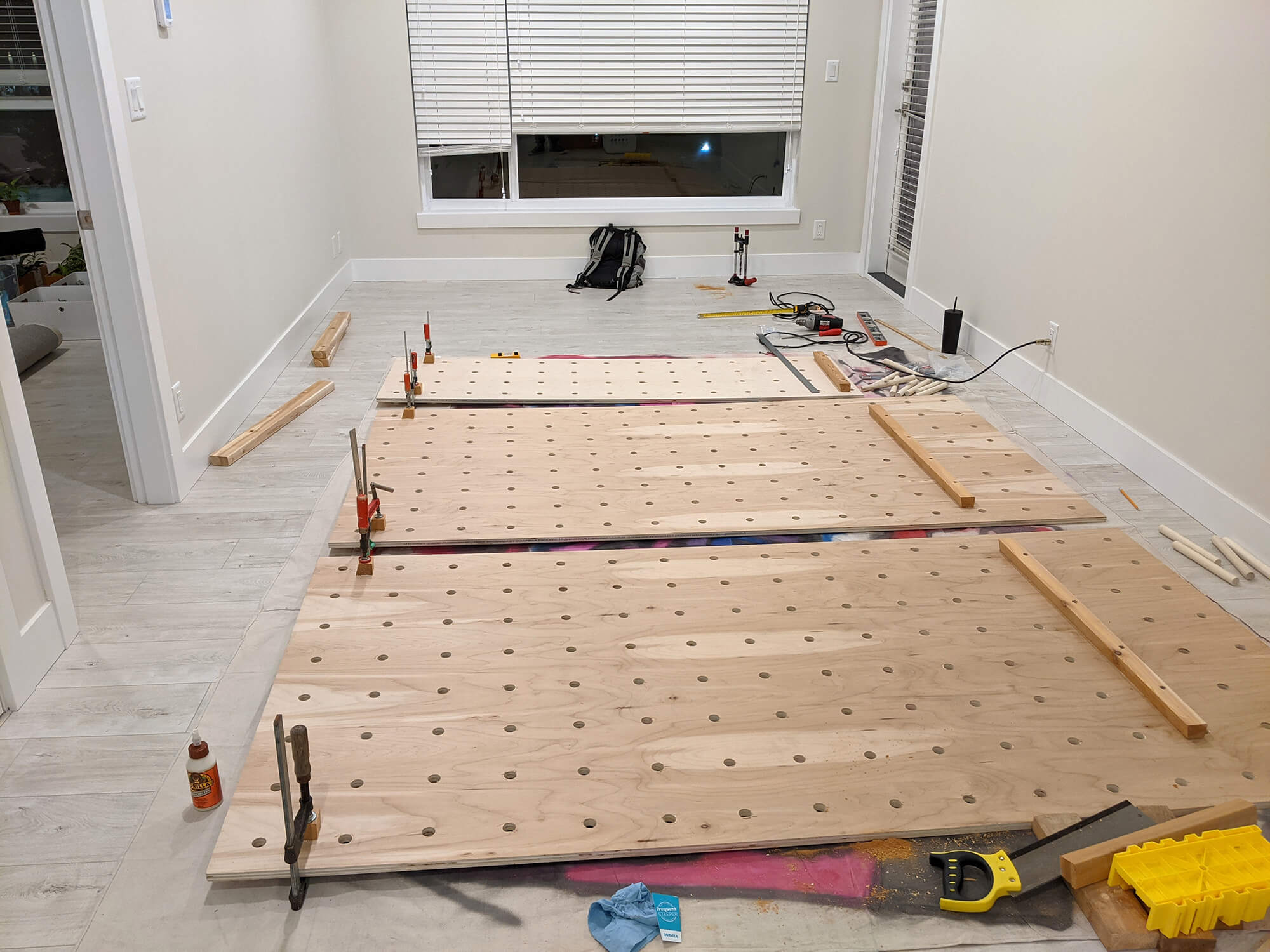 A work-in-progress of creating this green workspace with a giant pegboard wall