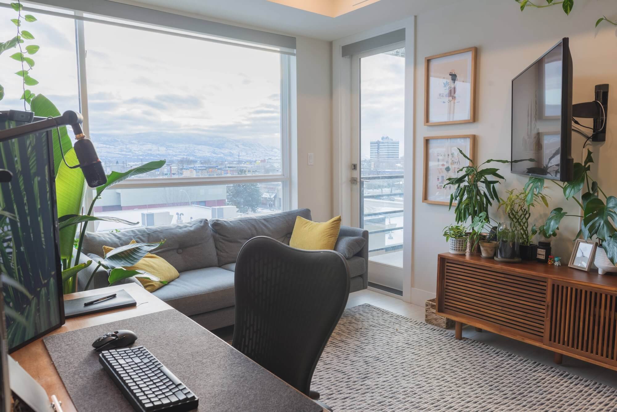 The living room with a home office setup in Kelowna, Canada