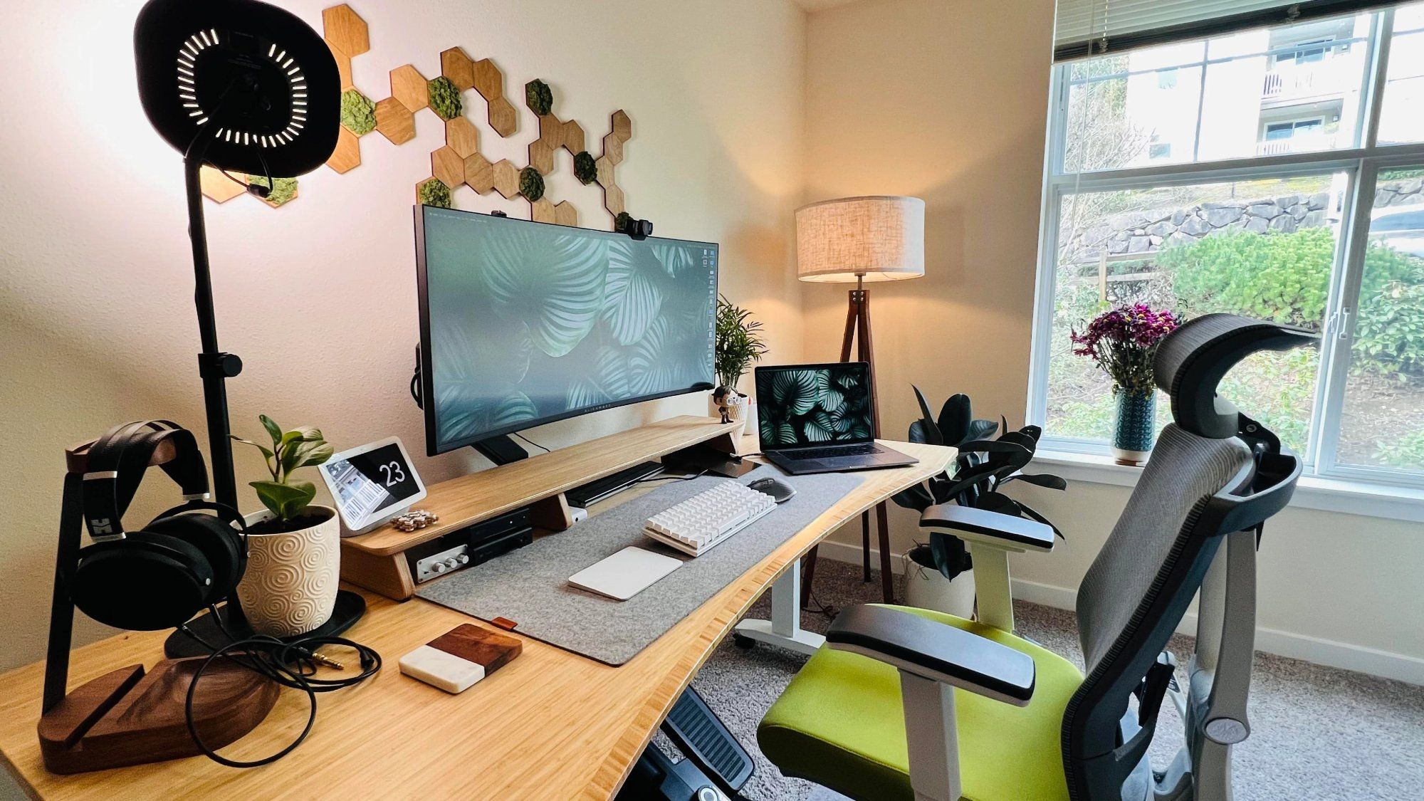 A home office setup featuring a Fully Jarvis bamboo standing desk