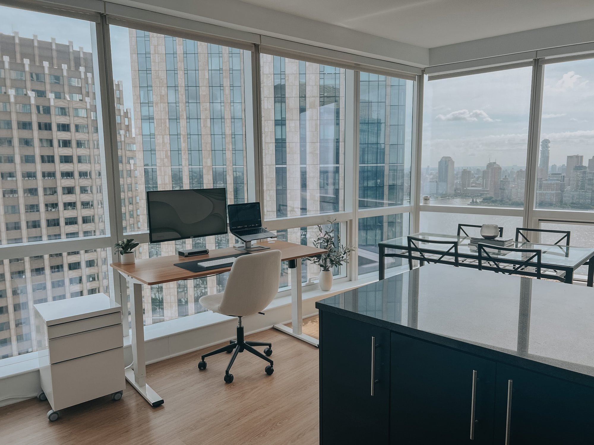 A minimal WFH desk setup featuring panoramic views over Jersey City