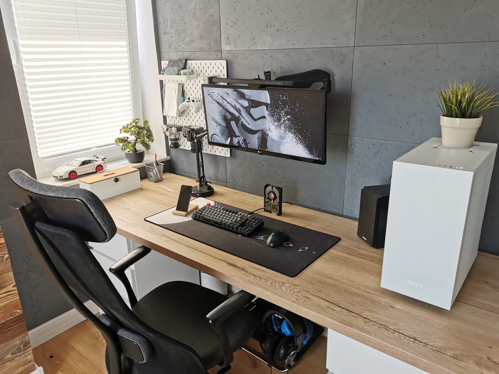 An IKEA home office setup with concrete wall panels