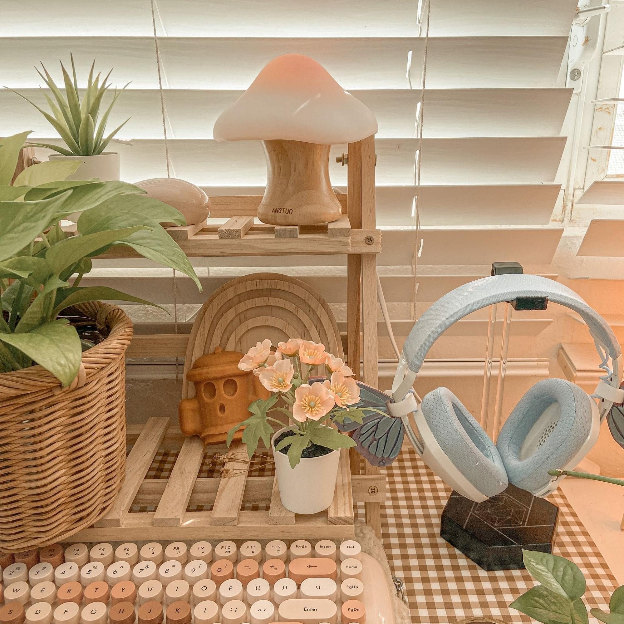 A cute home desk setup featuring the ANGTUO wooden mushroom lamp