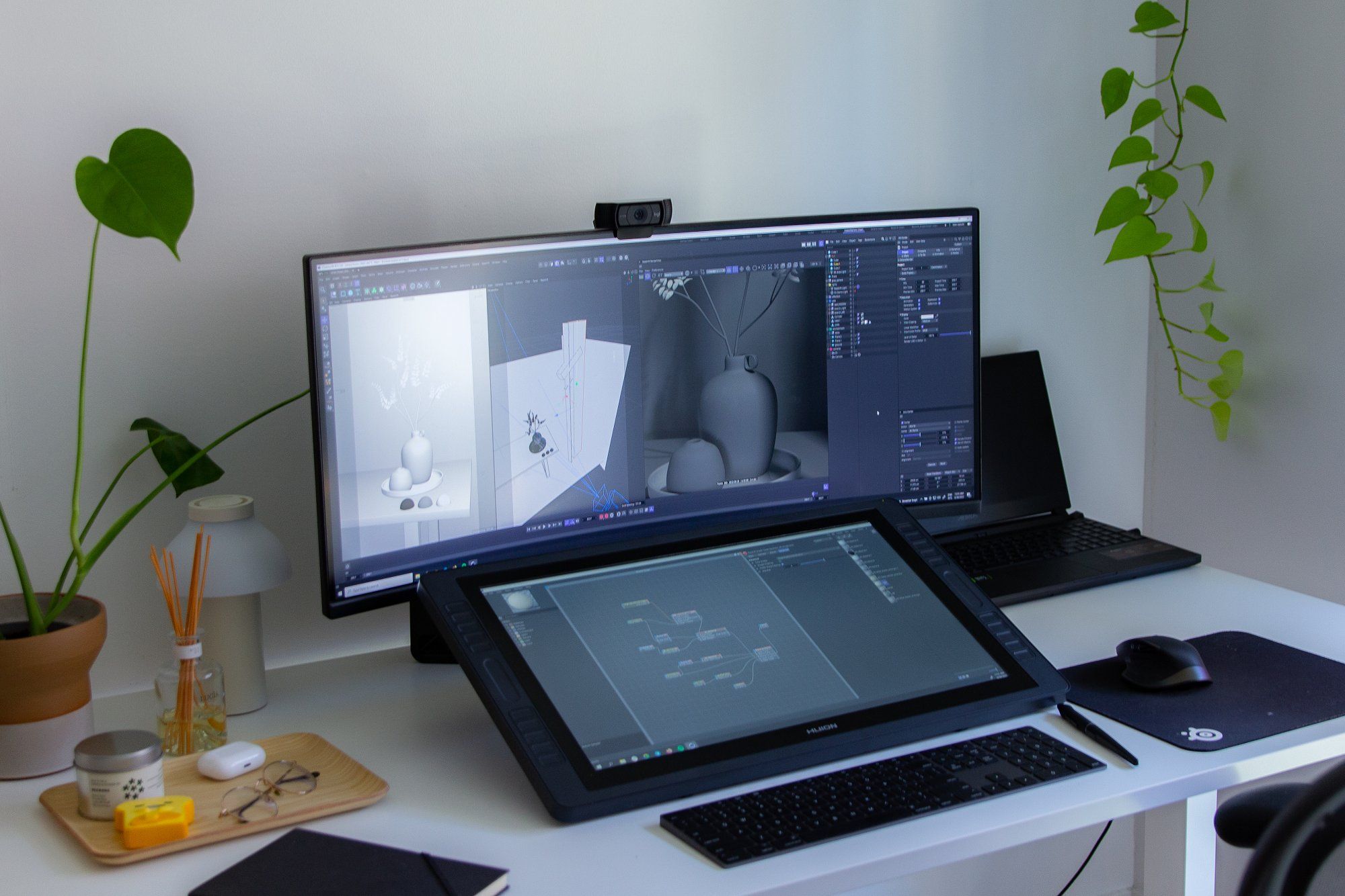 A minimal ergonomic desk setup with a Gigabyte ultrawide monitor and HUION Kamvas tablet