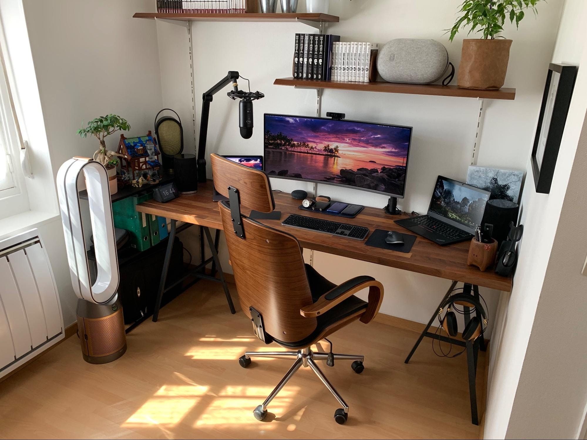 A walnut home office with a wide screen and long desk