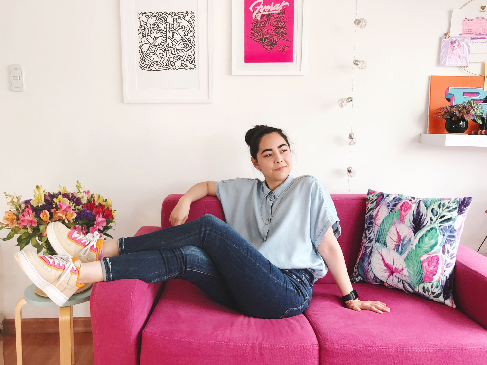 A lettering artist Nubikini on her pink sofa