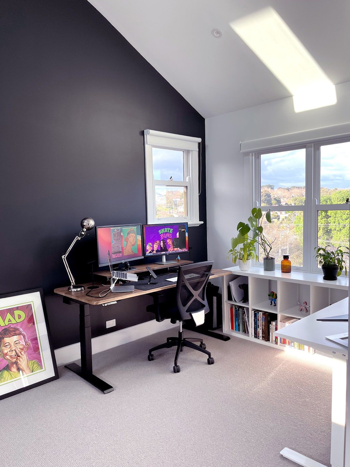 A home workspace with vaulted ceilings, big windows and some skylights to let the natural light in