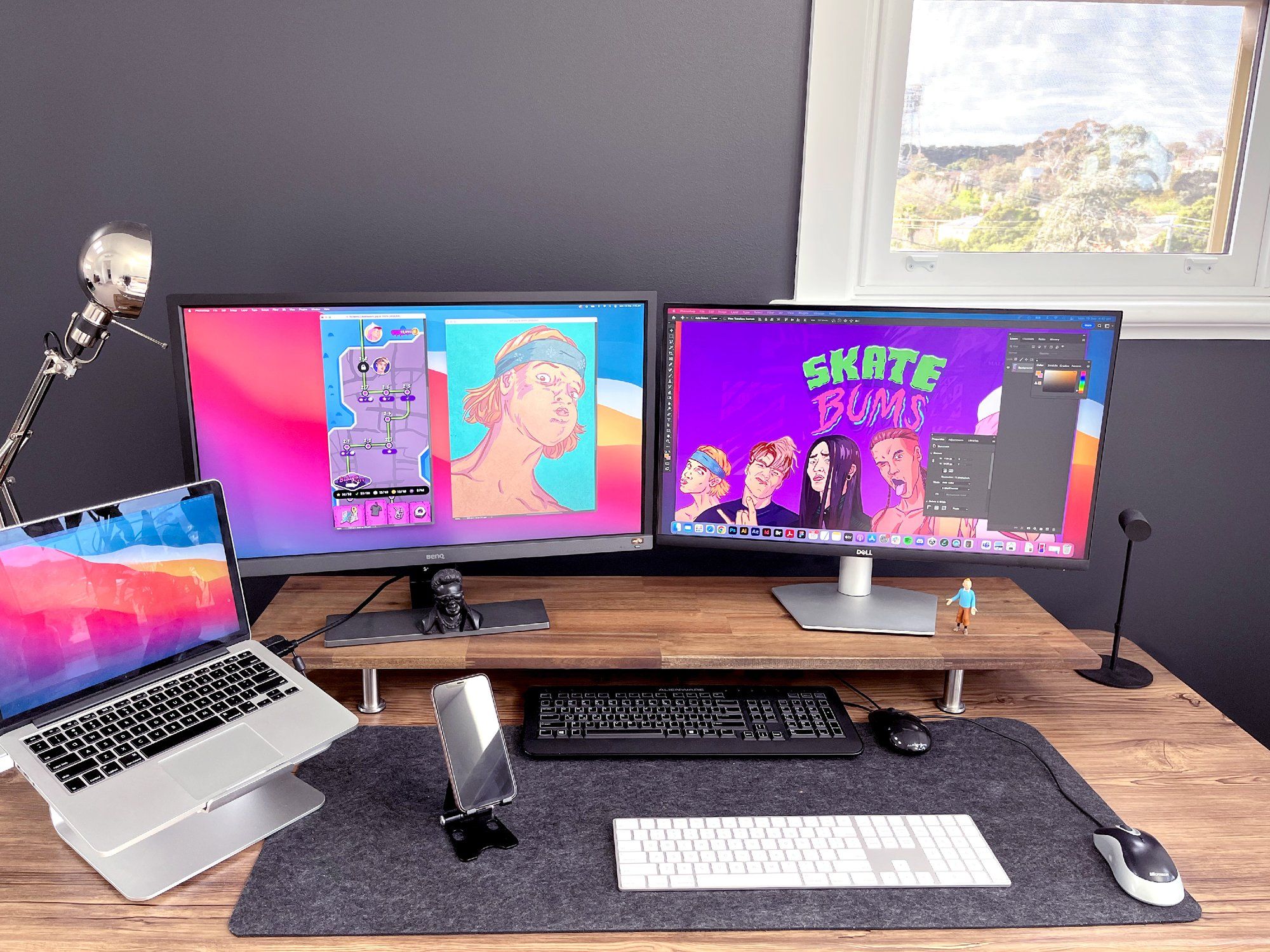 A designer desk setup with two keyboards, two monitos and two mice