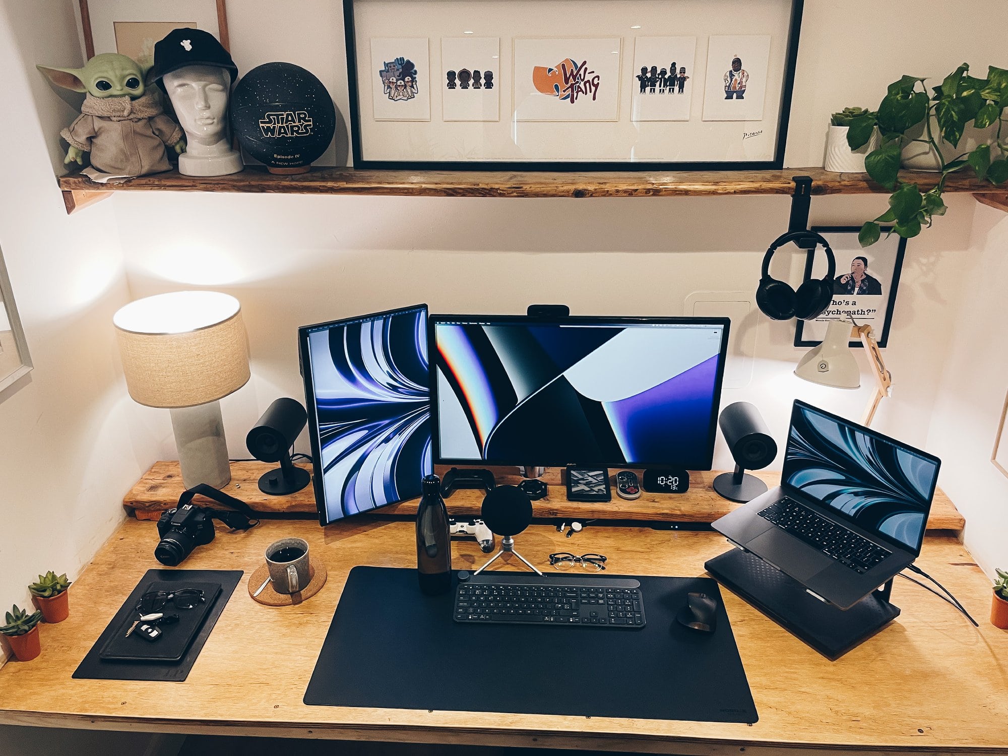 A DIY floating plywood desk setup with three screens