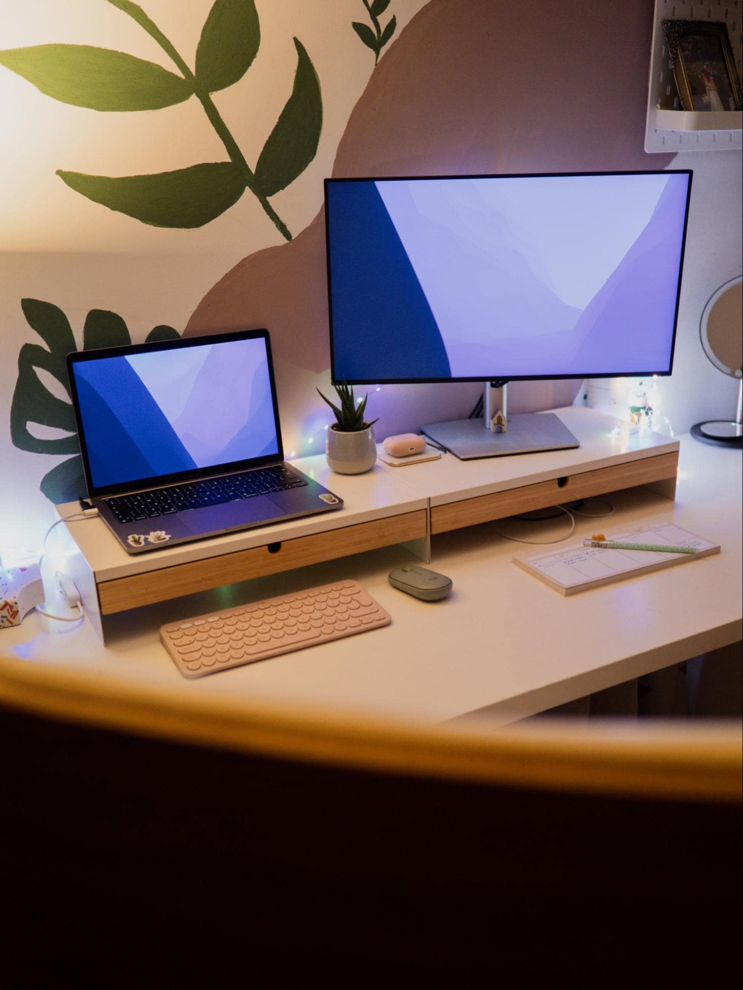 A workstation featuring a Dell U2422H UltraSharp monitor and MacBook Pro