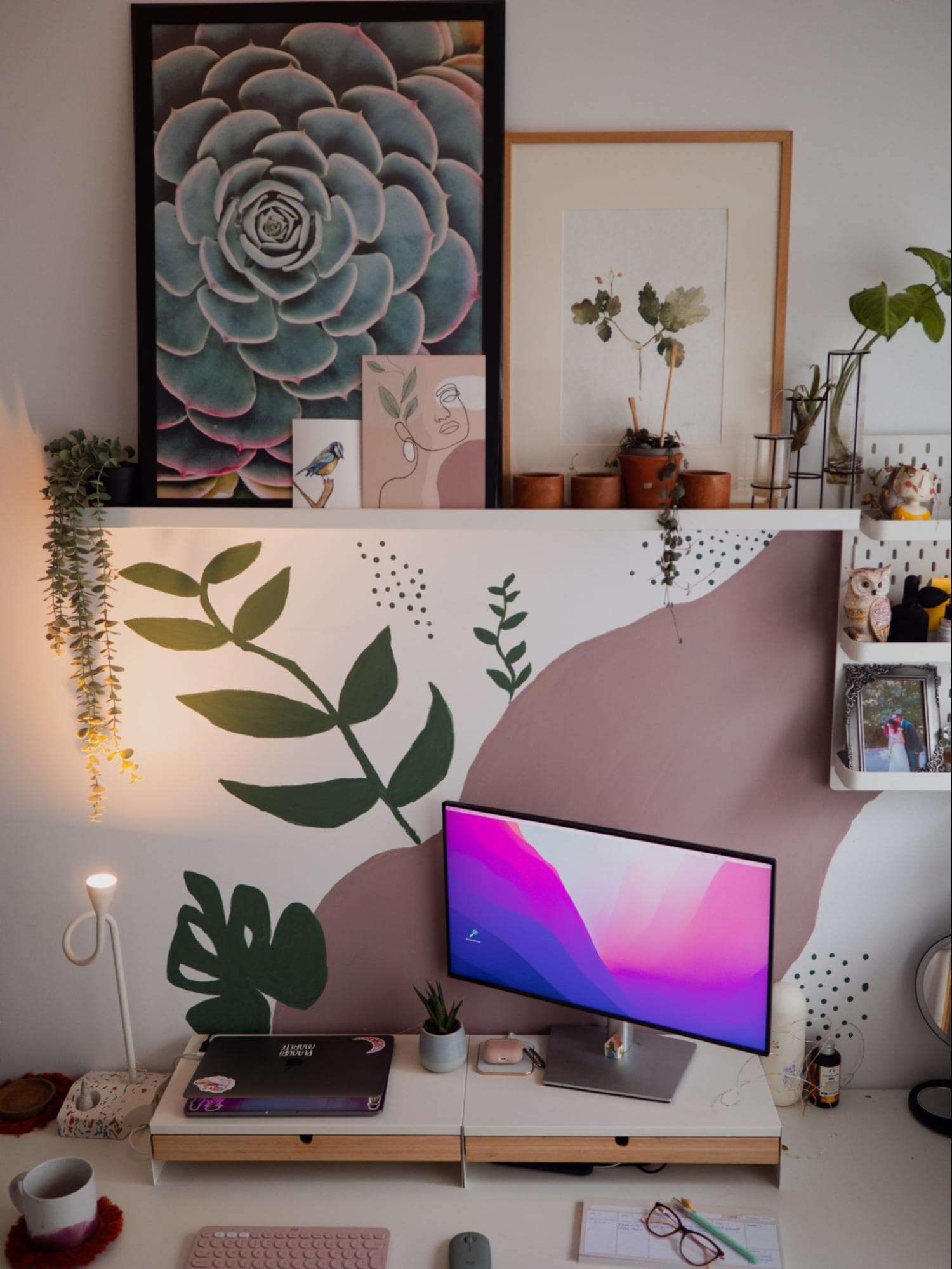 A well-organised desk setup featuring a soft, pastel colour palette with green accents