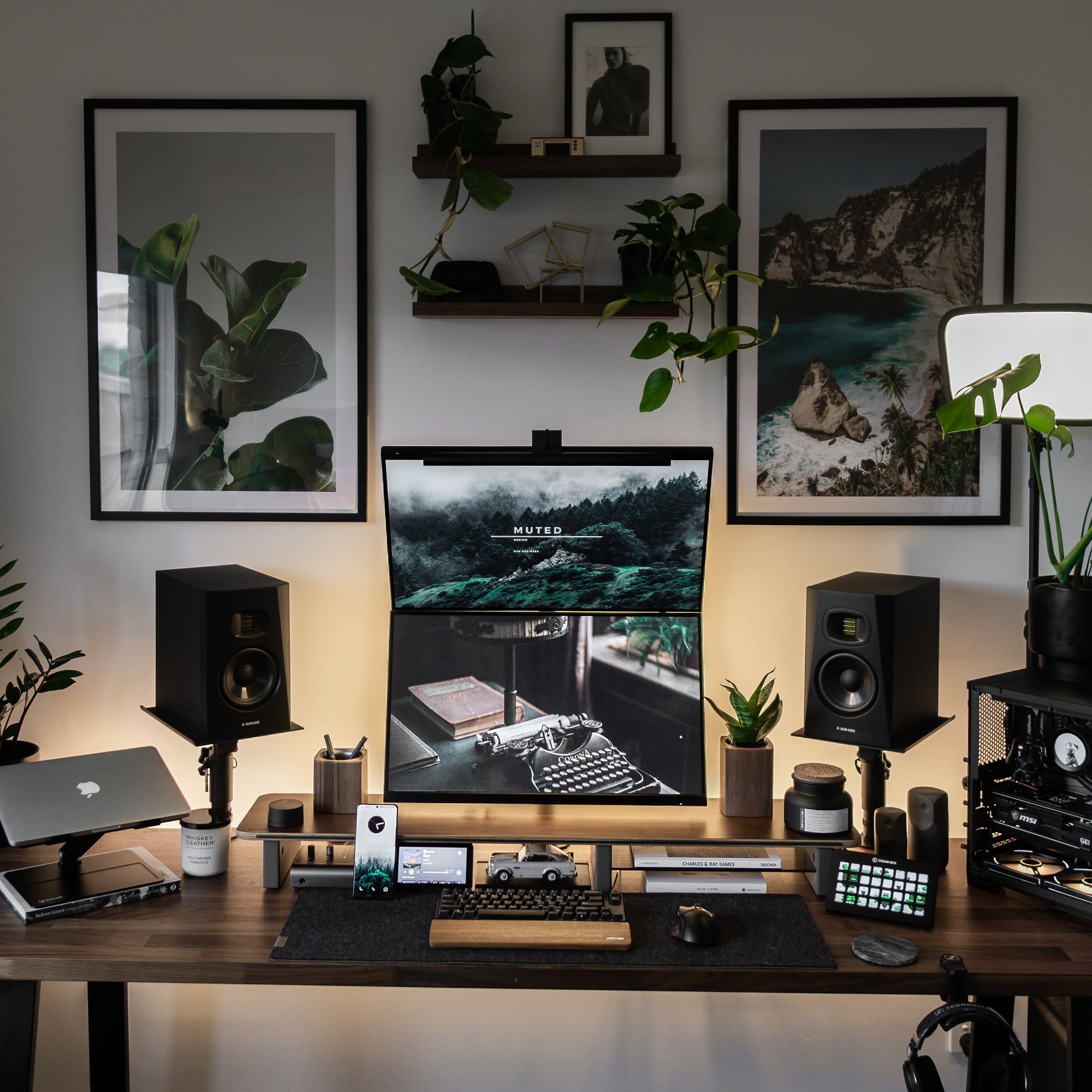 A symmetrical moody desk setup with two monitors stacked together vertically