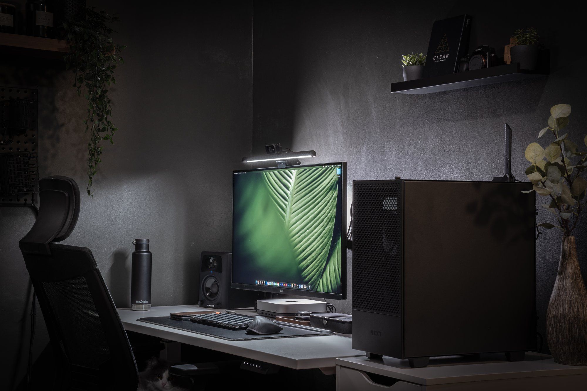 A well-organised WFH desk setup in dark tones