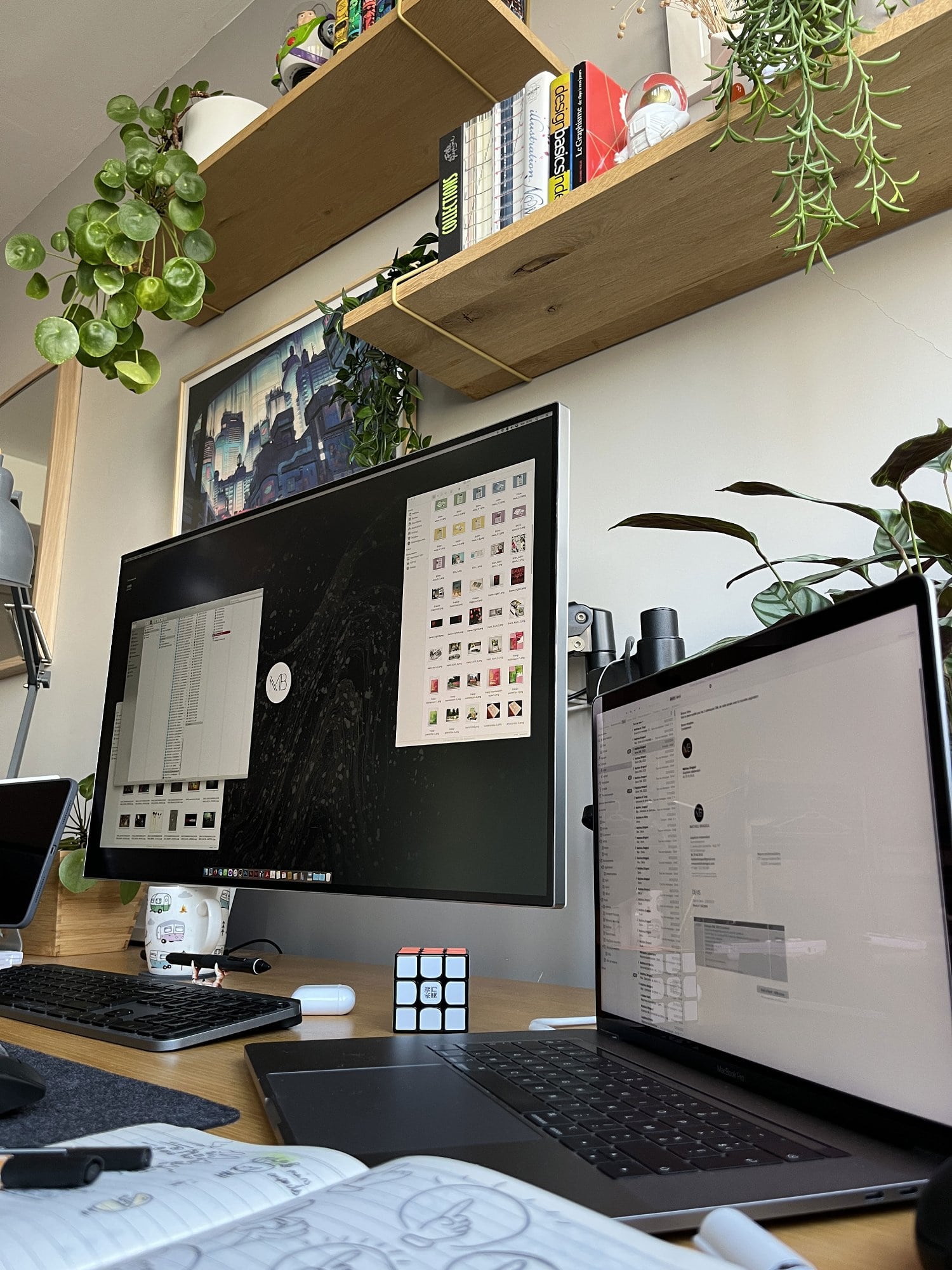 A productive home office desk setup with an LG monitor, a MacBook Pro, and a Logitech MX Keyboard for Mac