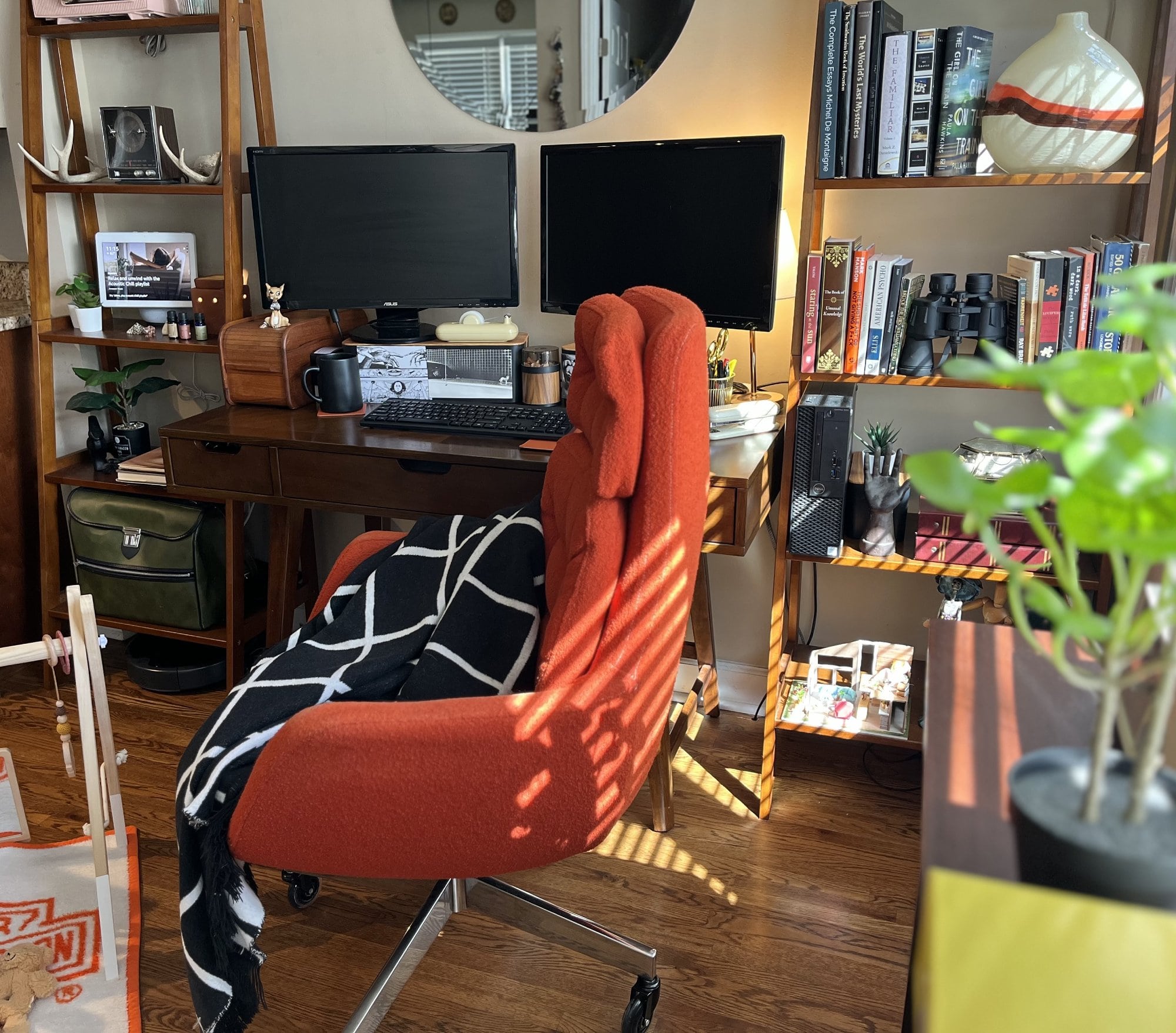 An orange mid-century chair with a throw in the home office
