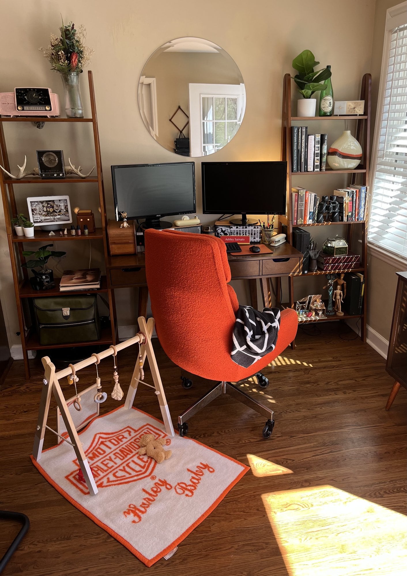 An orange Harley baby blanket next to the mid-century office chair of the same hue