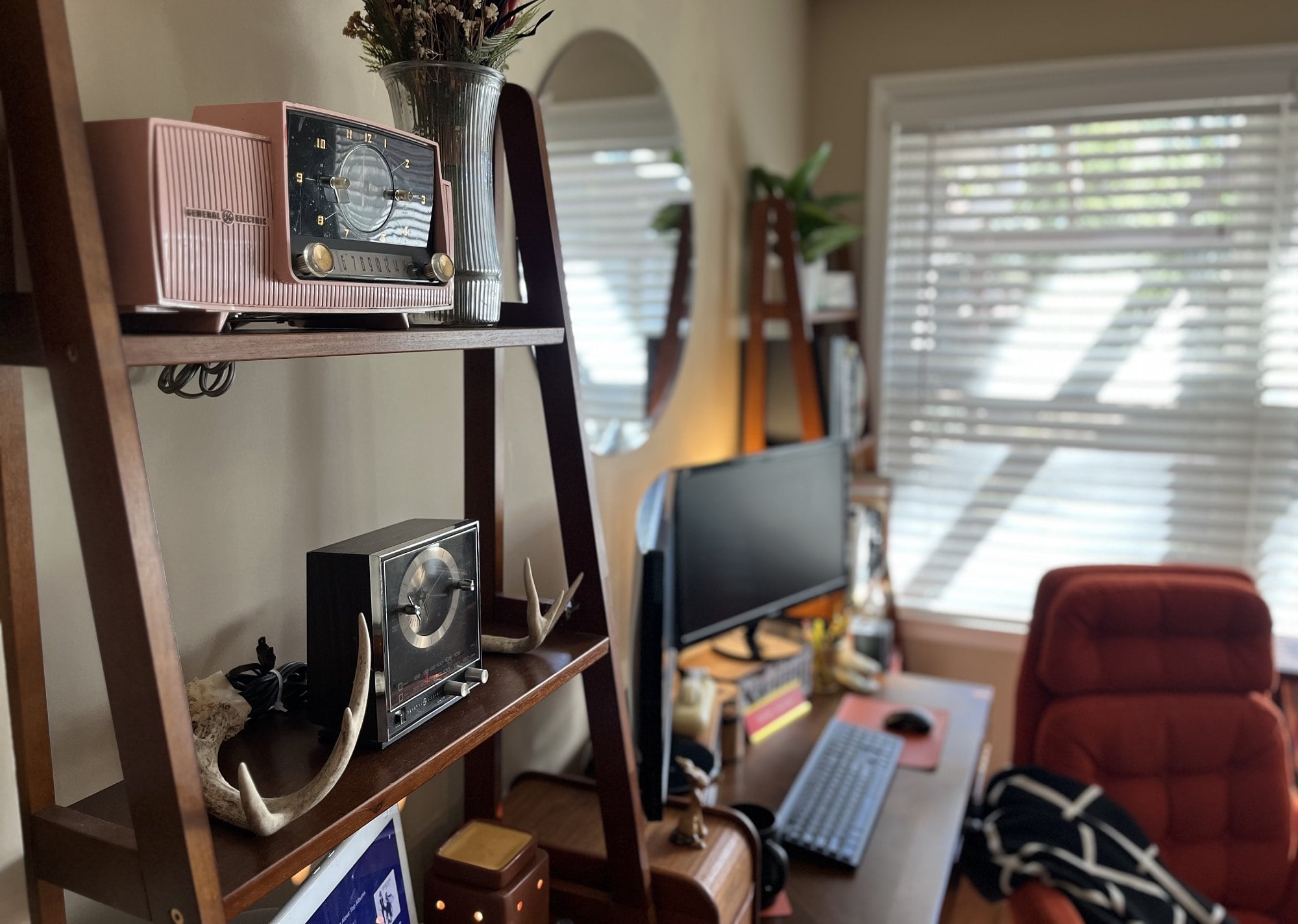 The collection of vintage clocks on a ladder bookshelf