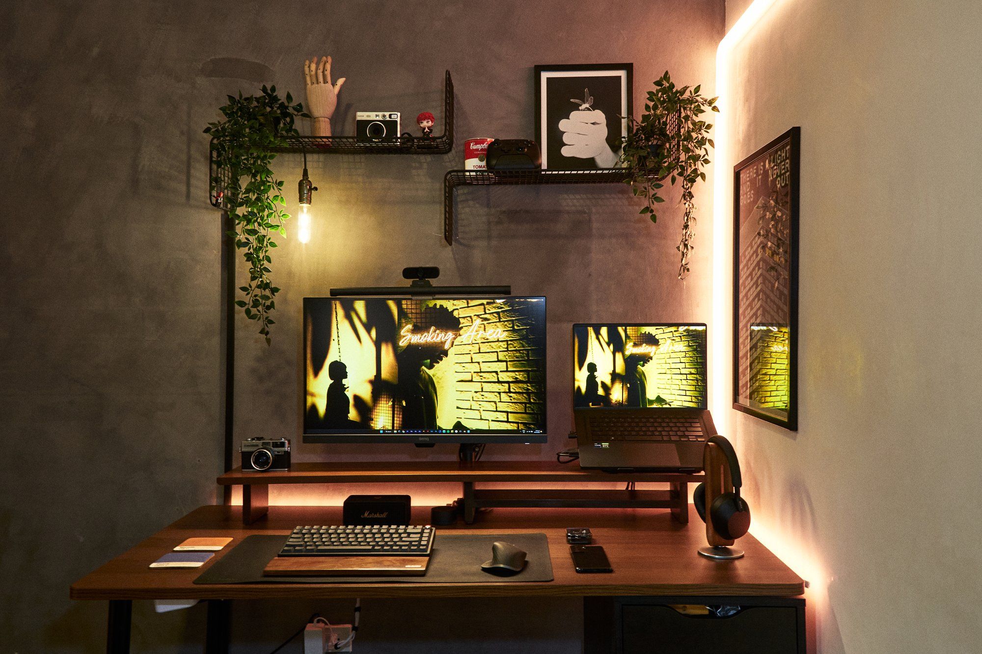 A well-designed, clean WFH desk setup with monochrome devices, peripherals, shelves, and wall art