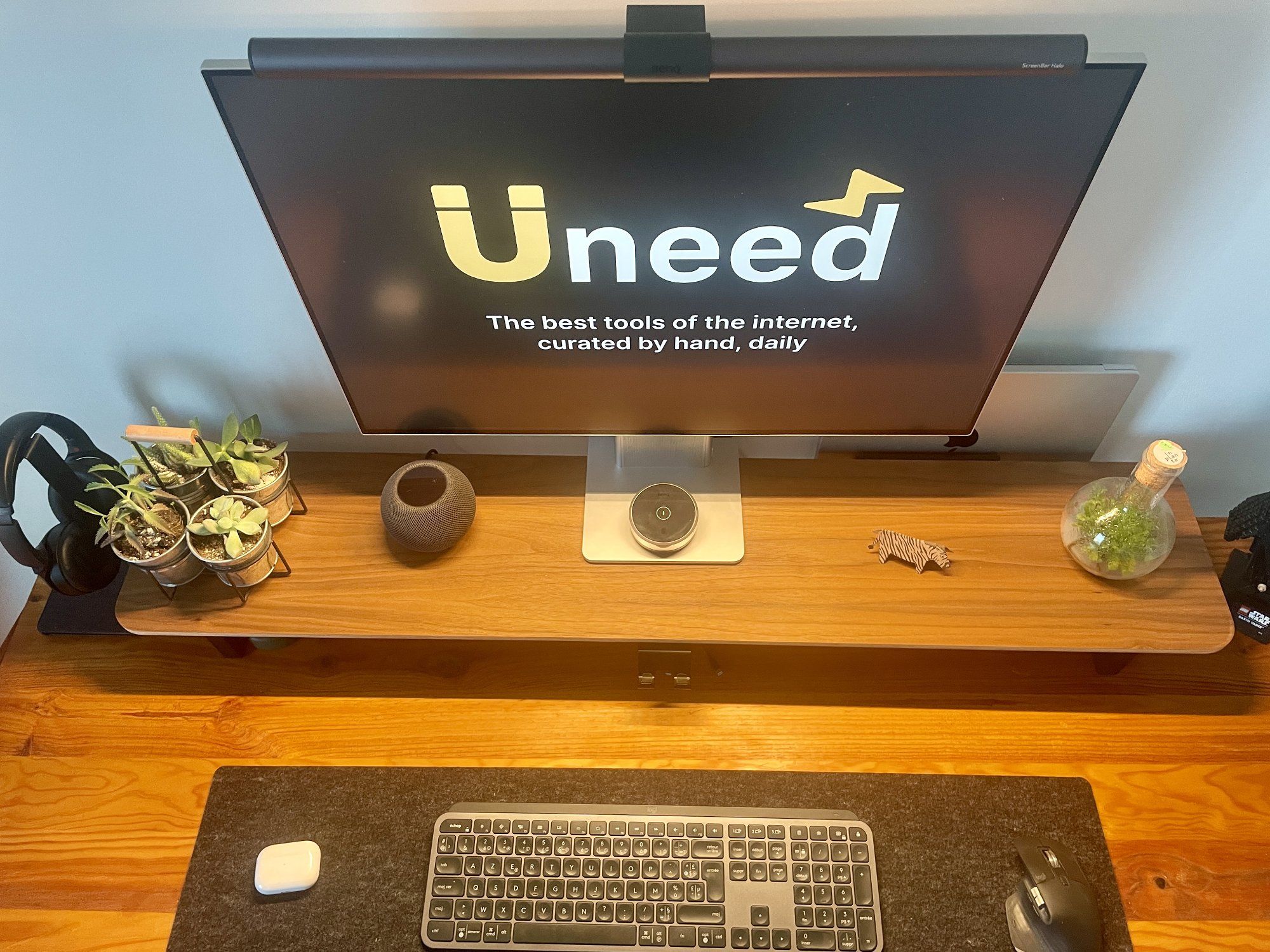 A top-down view of a clean and organised home desk setup in a small space in Nantes, France