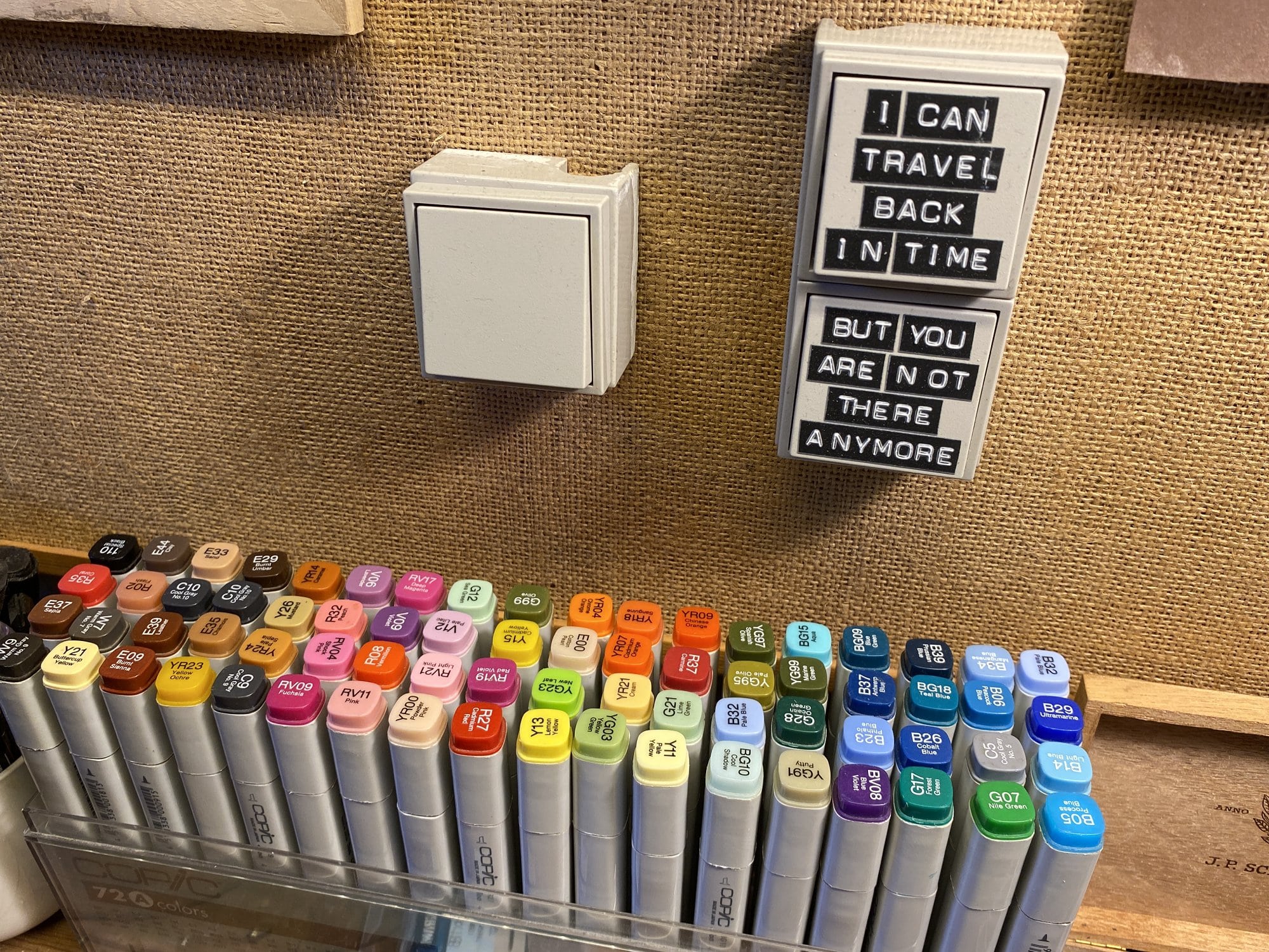 A set of Copic markers and letters on a switch that read “I can travel back in time, but you are not there anymore”