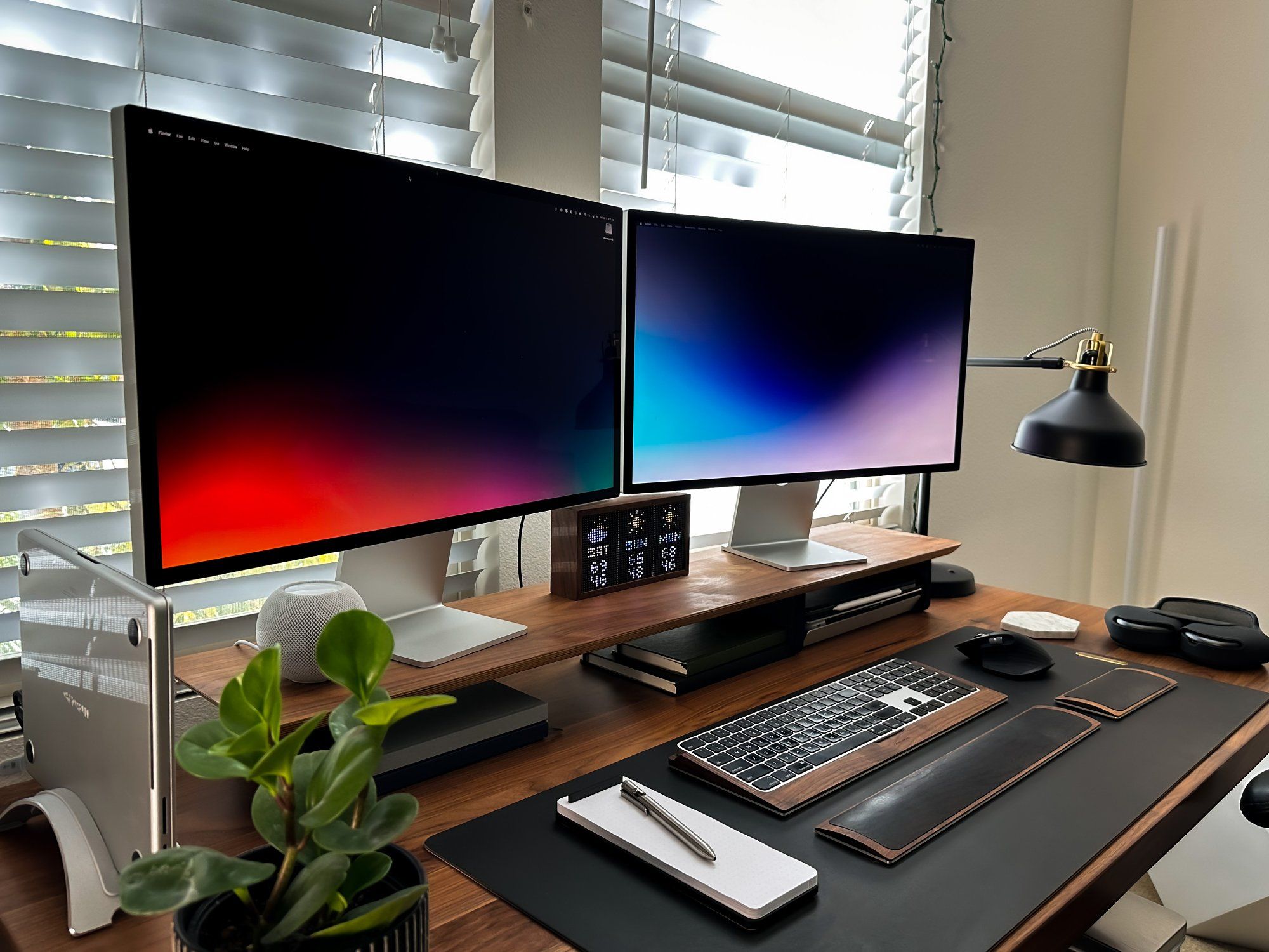 A dual monitor home workspace, featuring the desk shelf, a wrist pad, and a keyboard tray, all by Grovemade