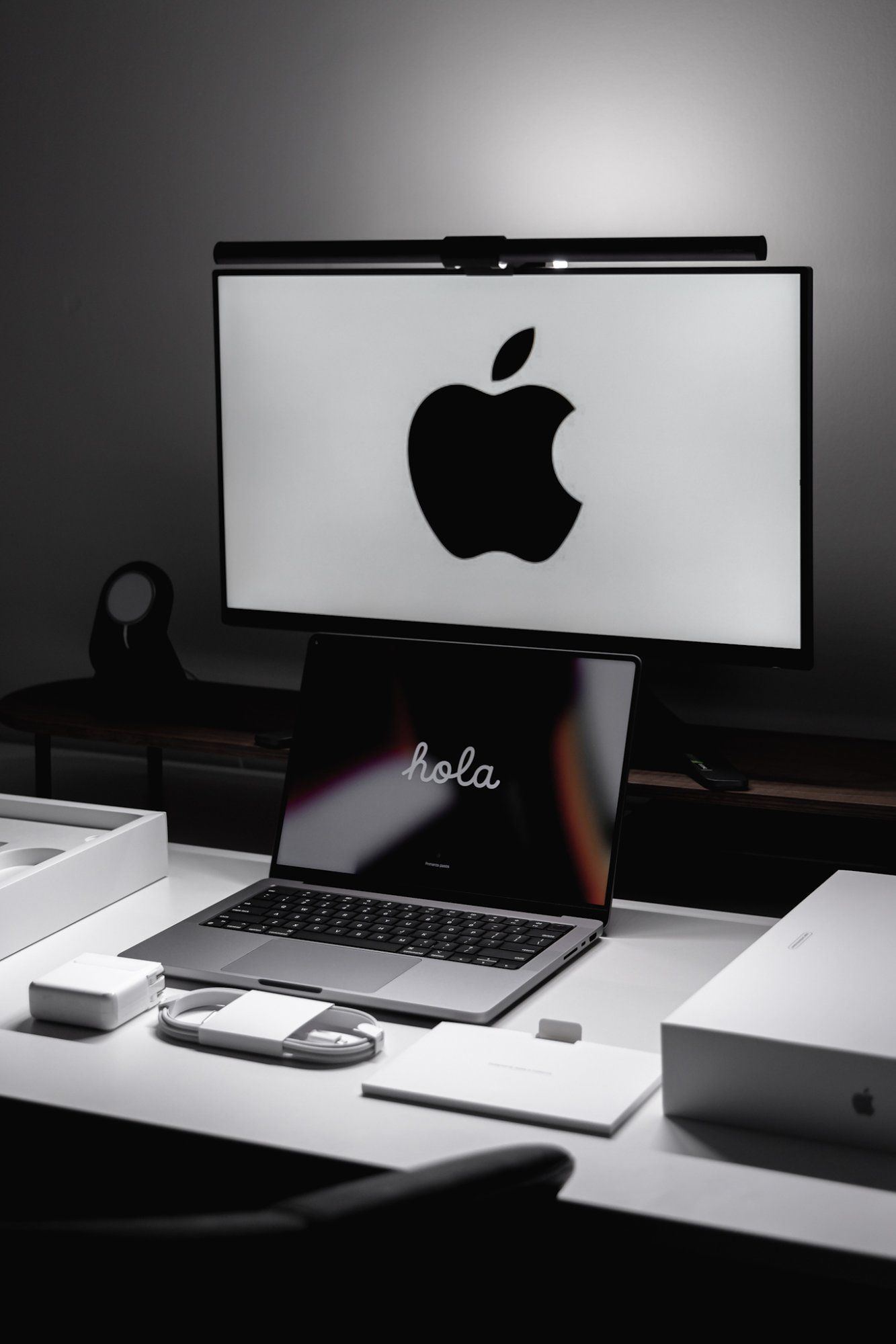 The MacBook laptop connected to an external monitor, which is positioned above the MacBook screen