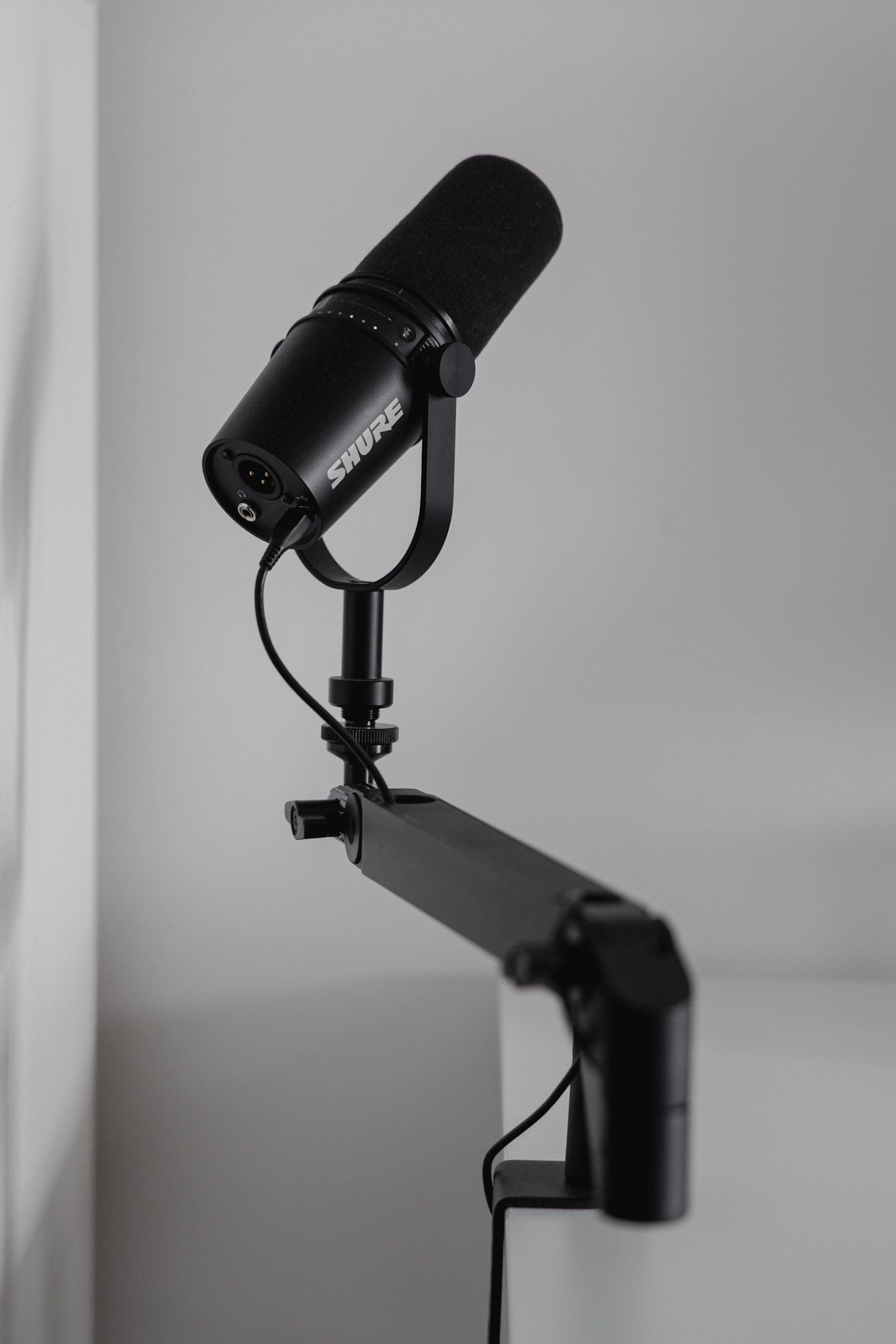 A Shure MV7 microphone on a stand