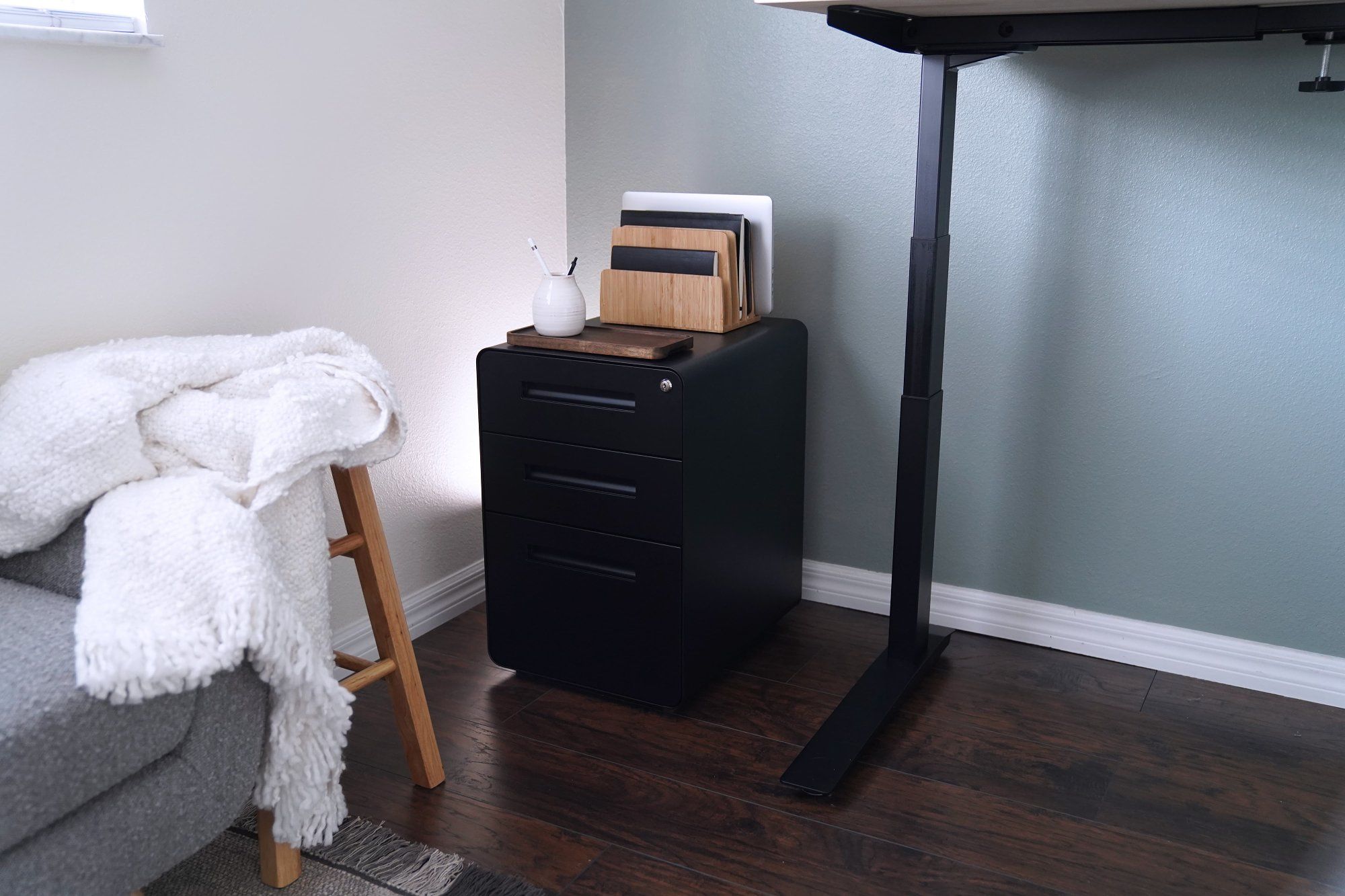 A home office corner with a Laura Davidson’s Stockpile Curve 3-drawer file cabinet in black