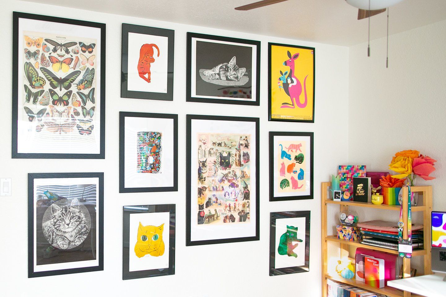 A corner of the bright and colourful room featuring wall posters with cats, kangaroos, and butterflies