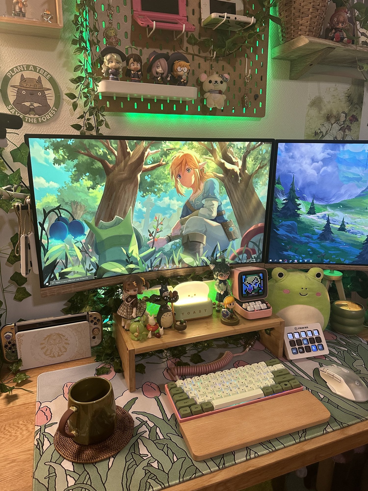 A close-up of a dual-monitor gaming setup in Paris, inspired by My Neighbor Totoro anime, The Legend of Zelda video game franchise, and other Japanese culture influences