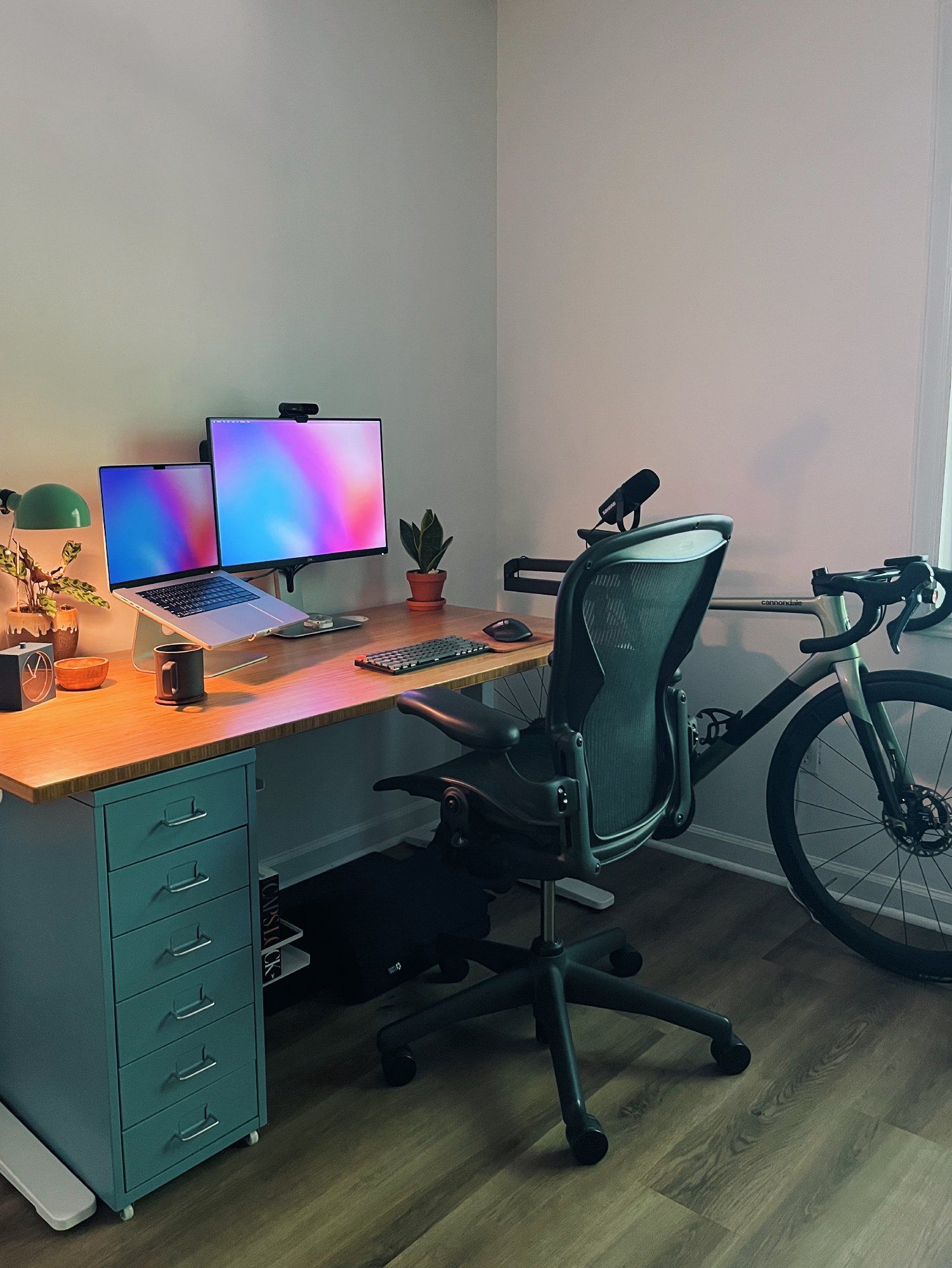 A standing desk setup with an ergonomic office chair and storage drawers