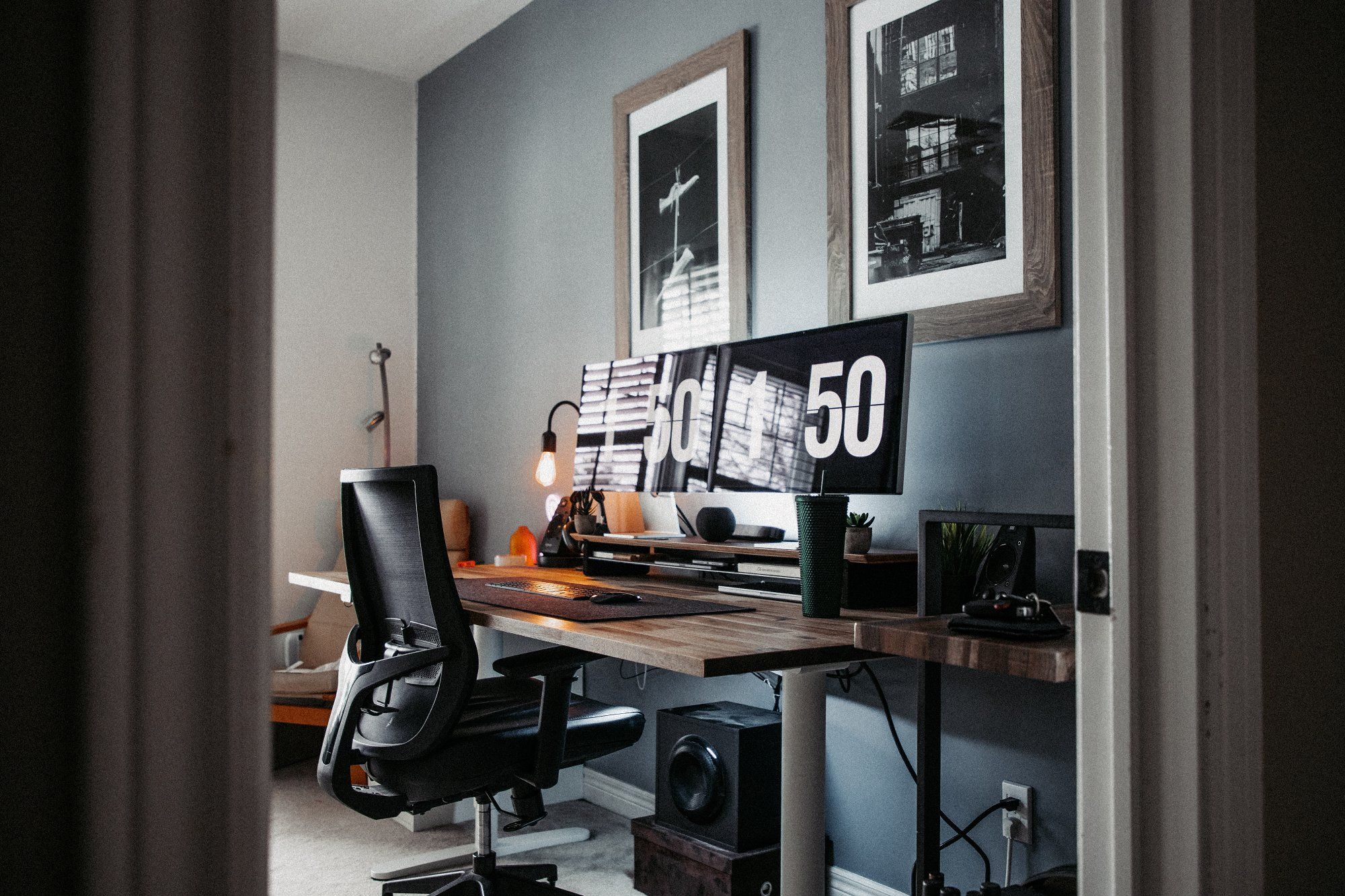 A view of a designer’s ergonomic home workspace from the right side of the doorway
