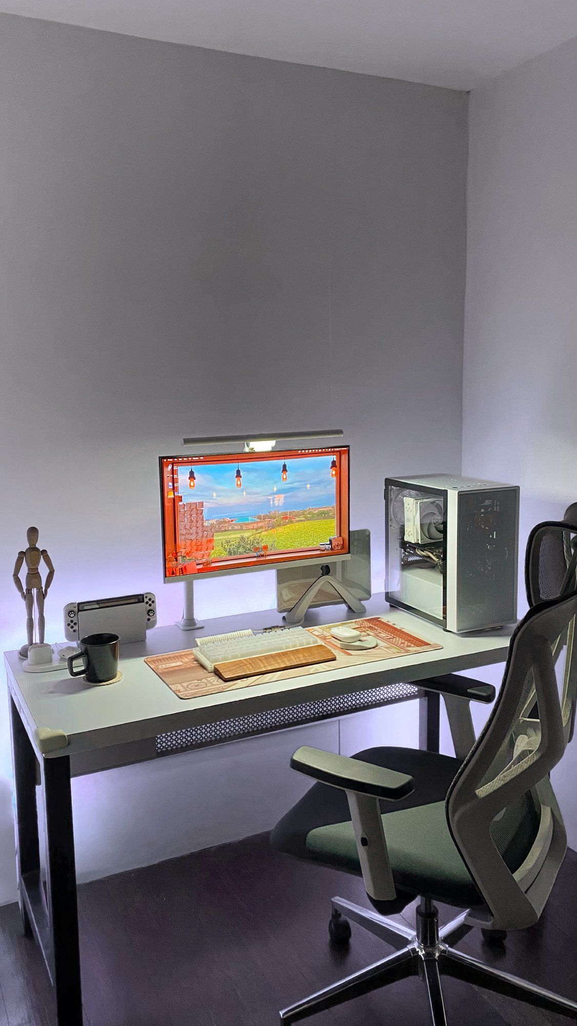 A home office setup in a small space with an Ofix F-16 Pro high-back ergonomic chair