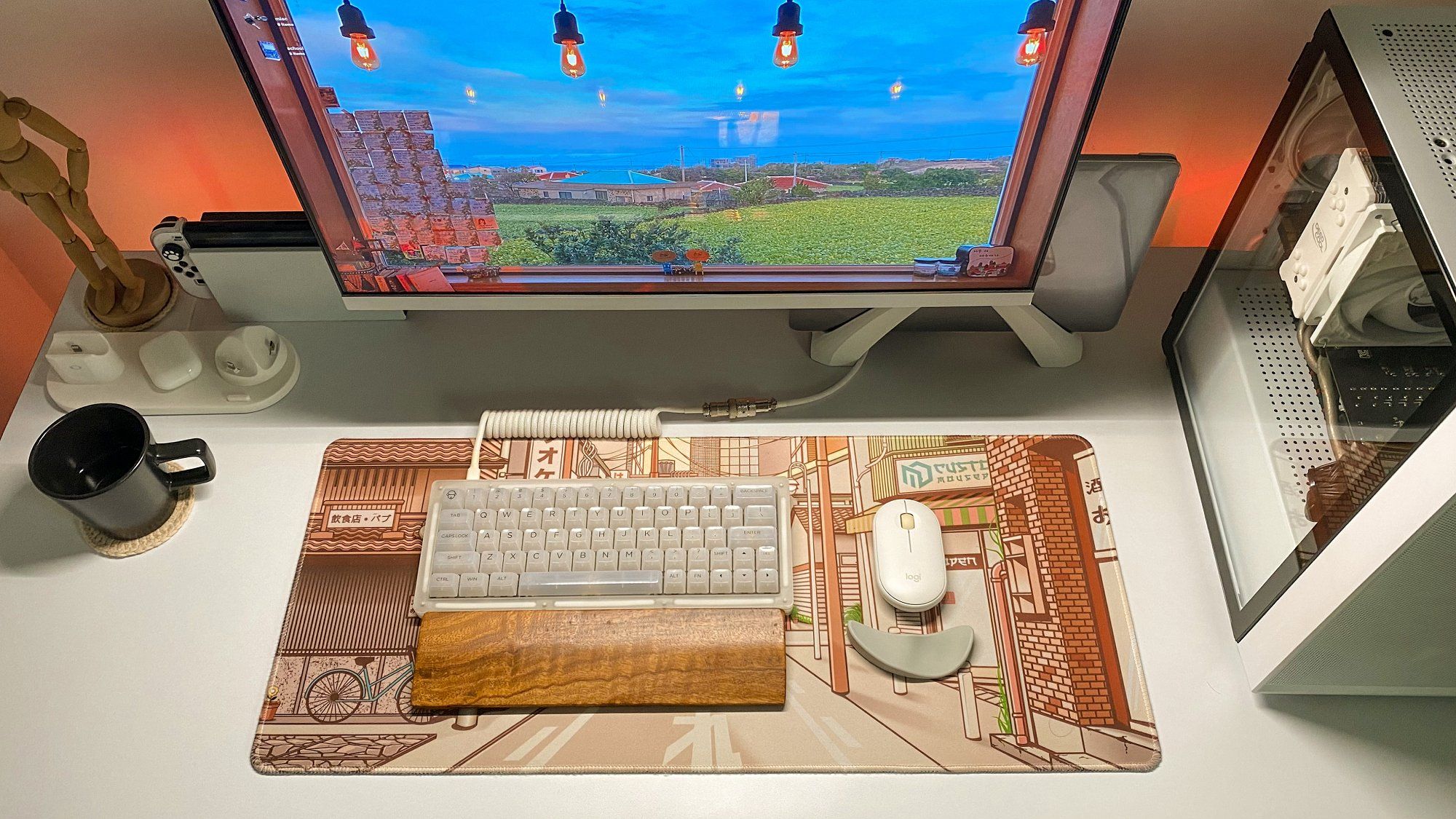 A designer’s desk setup featuring a Samsung 24″ Bezel-less FHD monitor, a custom Akko ACR64 keyboard, and a Logitech Pebble M350 mouse on the Kyoto Tori MD Custom Mousepad