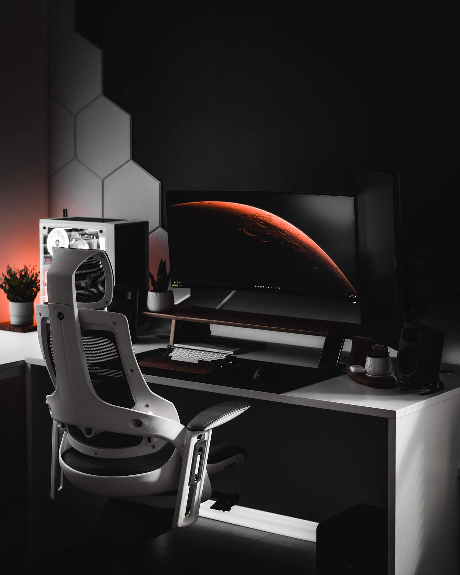 A futuristic gaming setup with an ergonomic chair and hexagonal wall panels