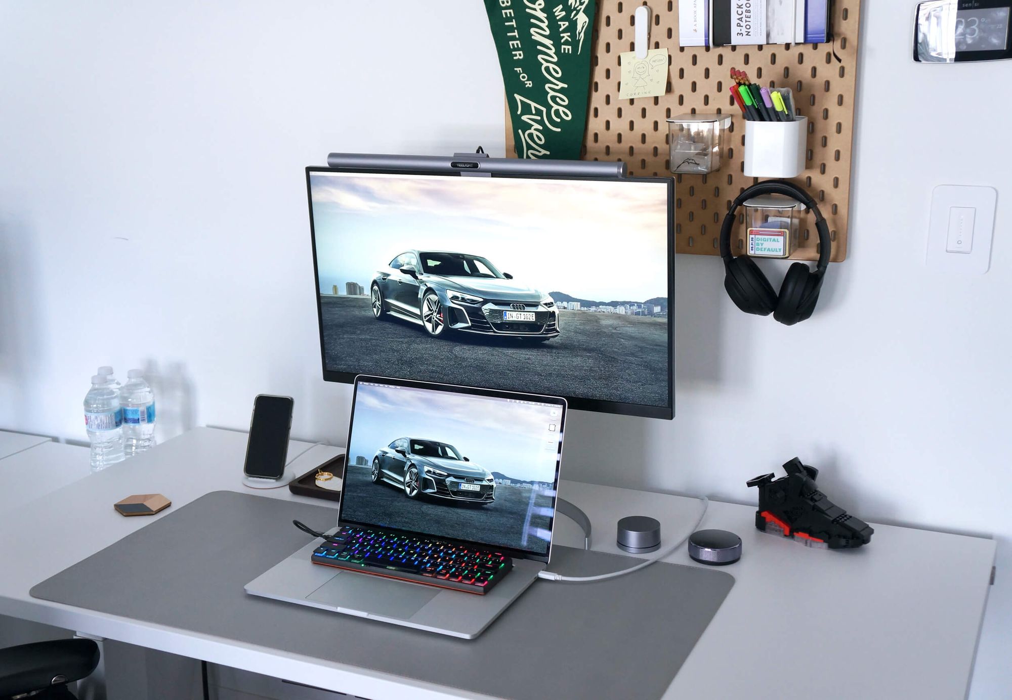 A minimal home office desk setup with an IKEA SKÅDIS pegboard