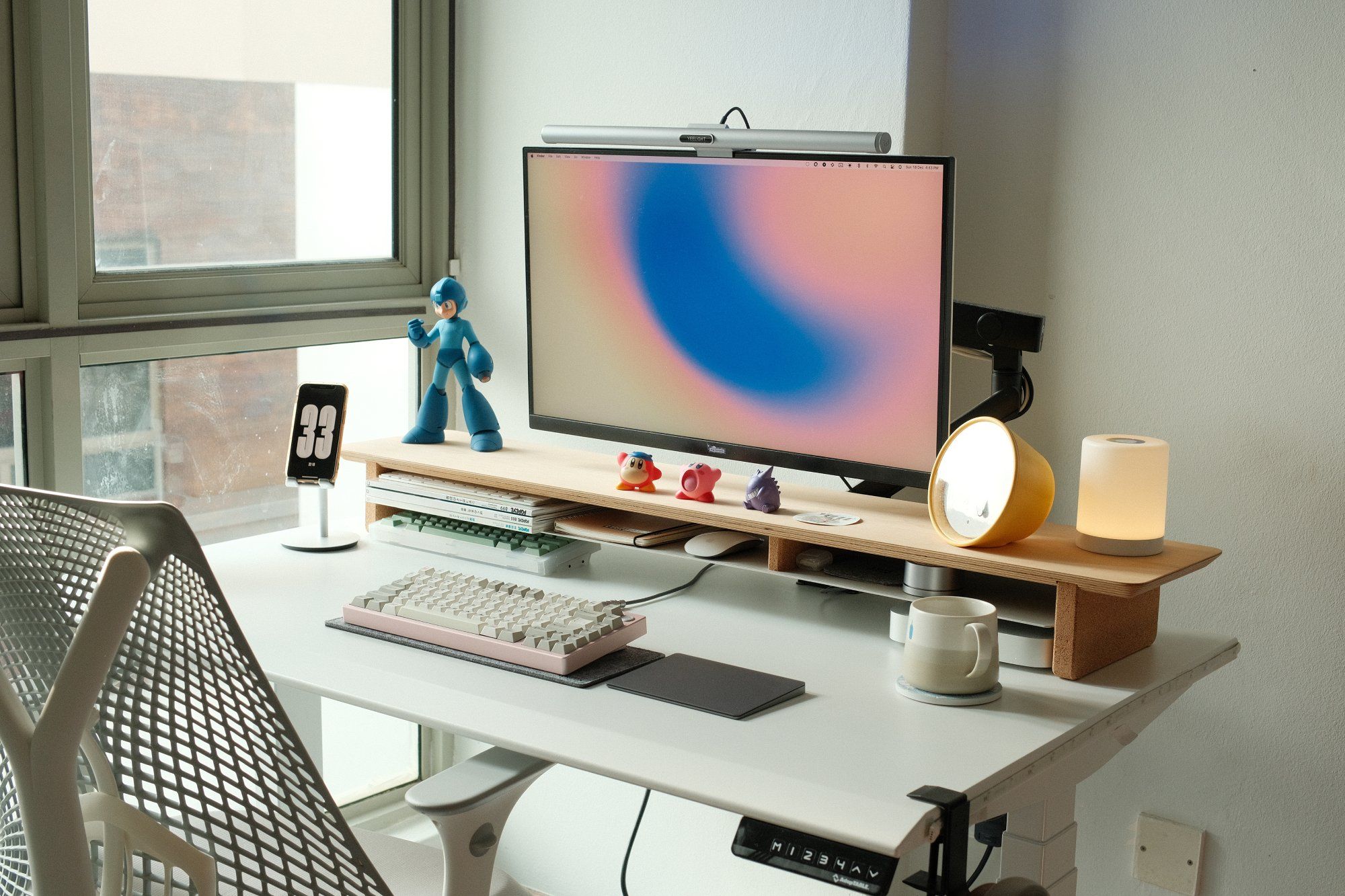 A minimal standing desk setup with several mechanical keyboards