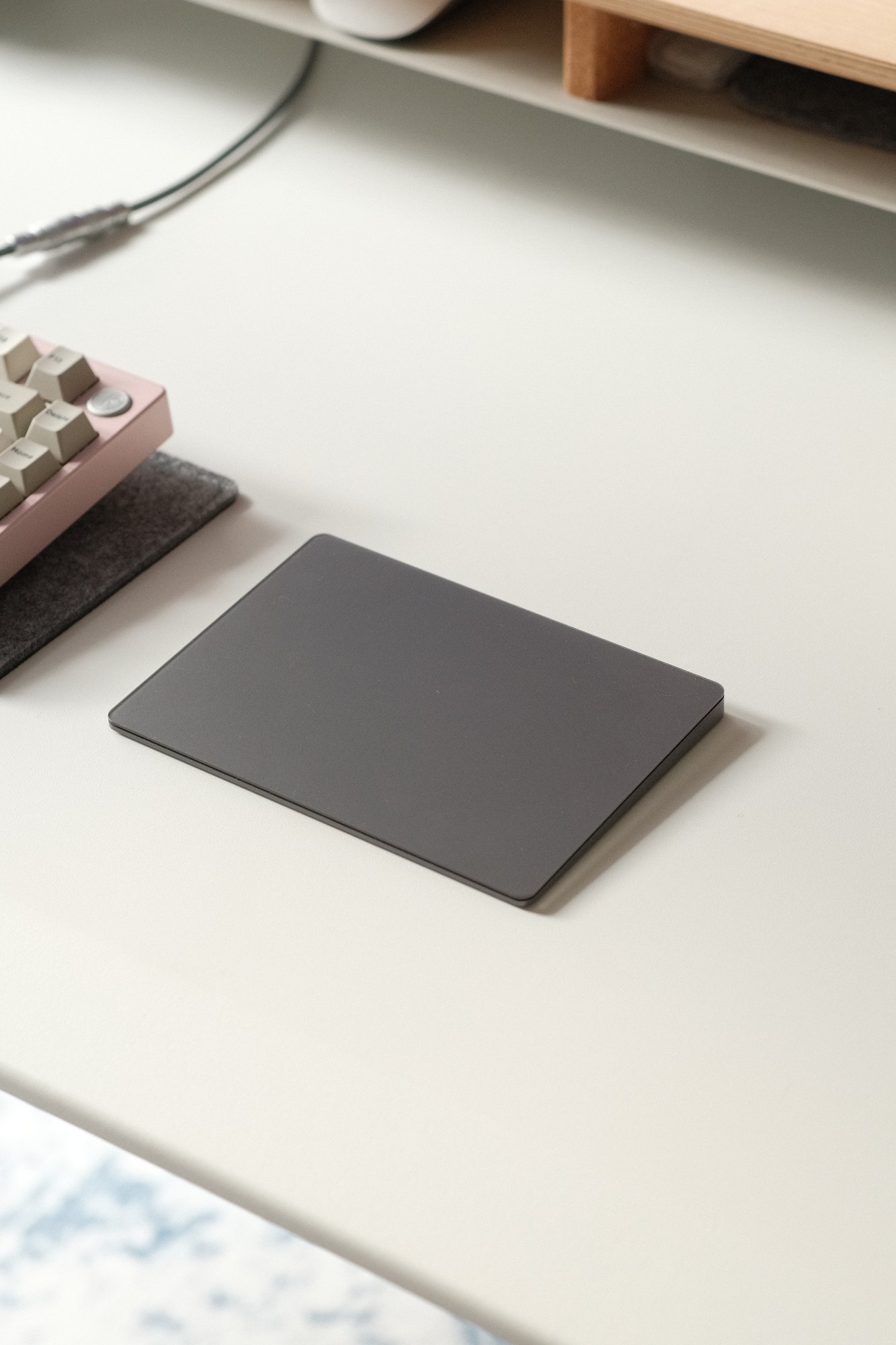 The Space Grey Apple Magic Trackpad at the desk setup
