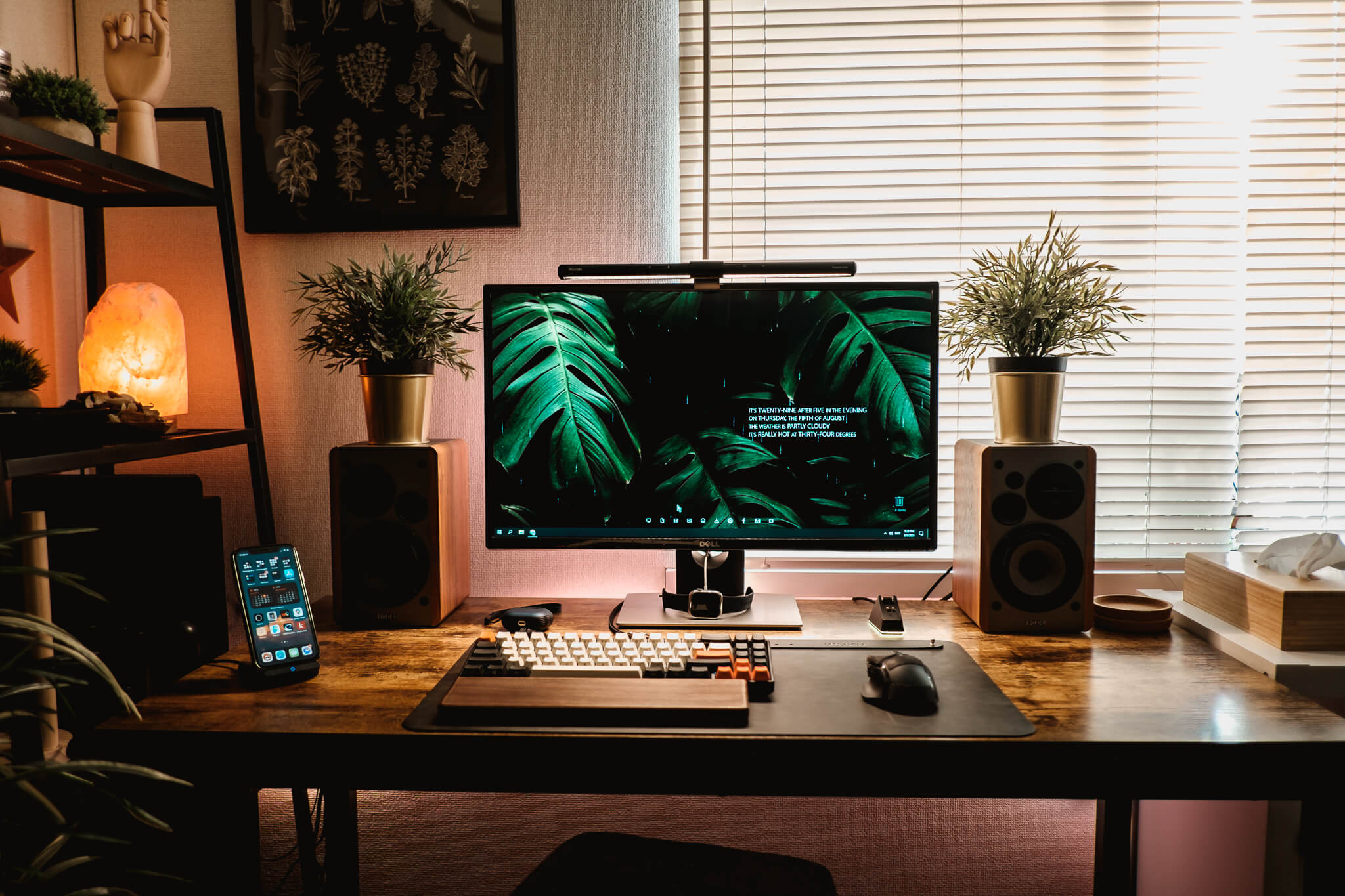A cosy industrial dark desk setup with hints of nature